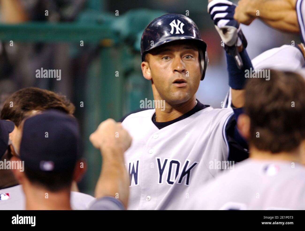 Derek Jeter of the New York Yankees is congratulated by teammates after scoring in the fifth inning of 8-6 loss to the Los Angeles Angels of Anaheim a Stock Photo