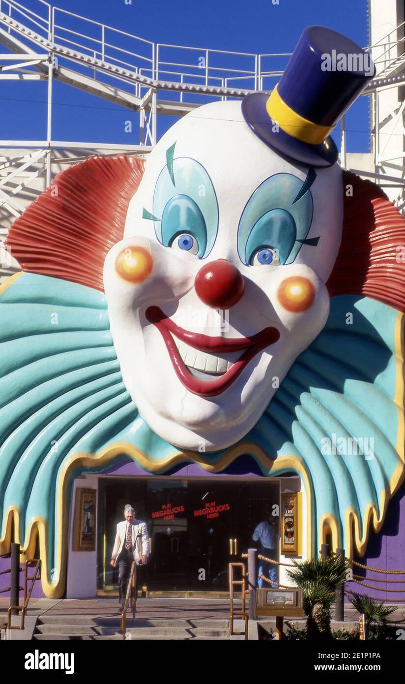 Man exiting casino n Las Vegas with a giant clown over doorway Stock