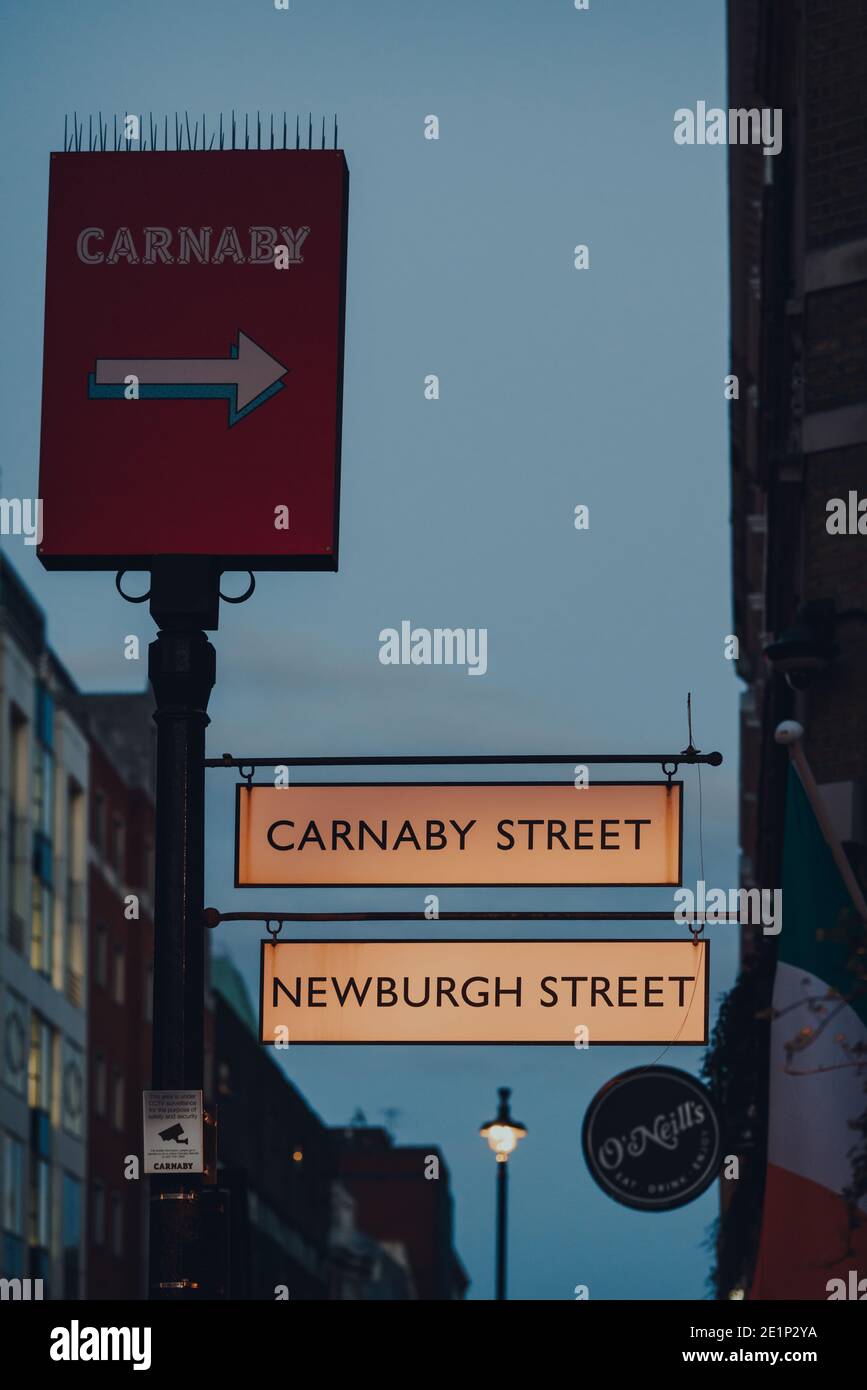 London, UK - November 19, 2020: Directional sign to Newburgh Street and Carnaby Street in Soho, London, and area famous for numerous coffee shops, pub Stock Photo