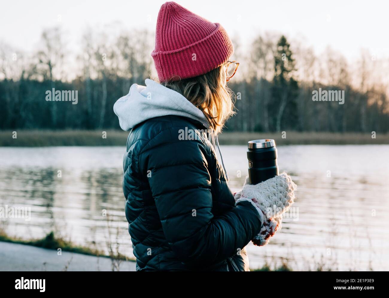 woman holding a hot drink after cold water swimming in Sweden Stock