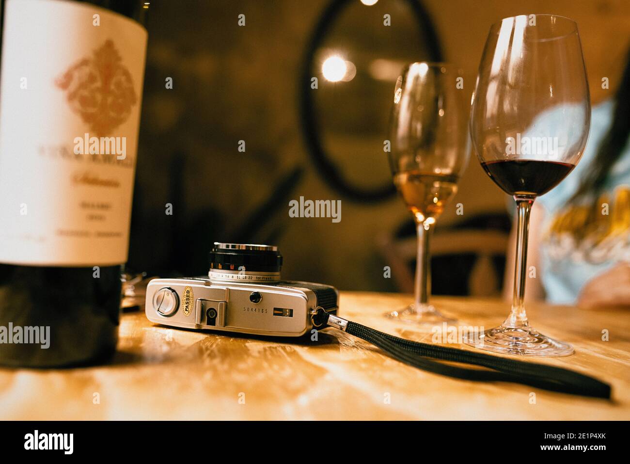 Vintage camera with a glass of wine Stock Photo