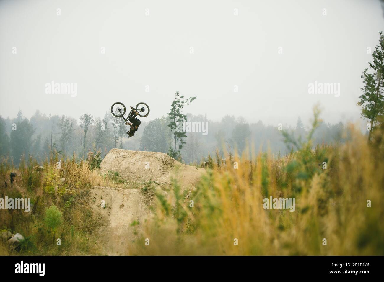 Mountain biker flipping a jump in Bellingham Washington Stock Photo
