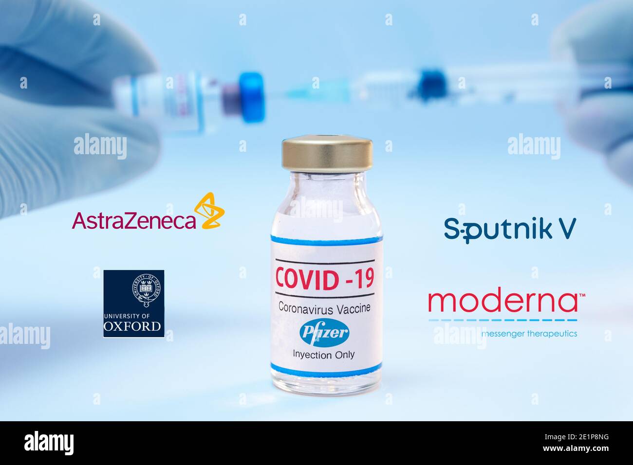 Bottle of Pfizer coronavirus vaccine with the Sputnik V, Moderna, Astra Zeneca and Oxford University logos as background. Stock Photo