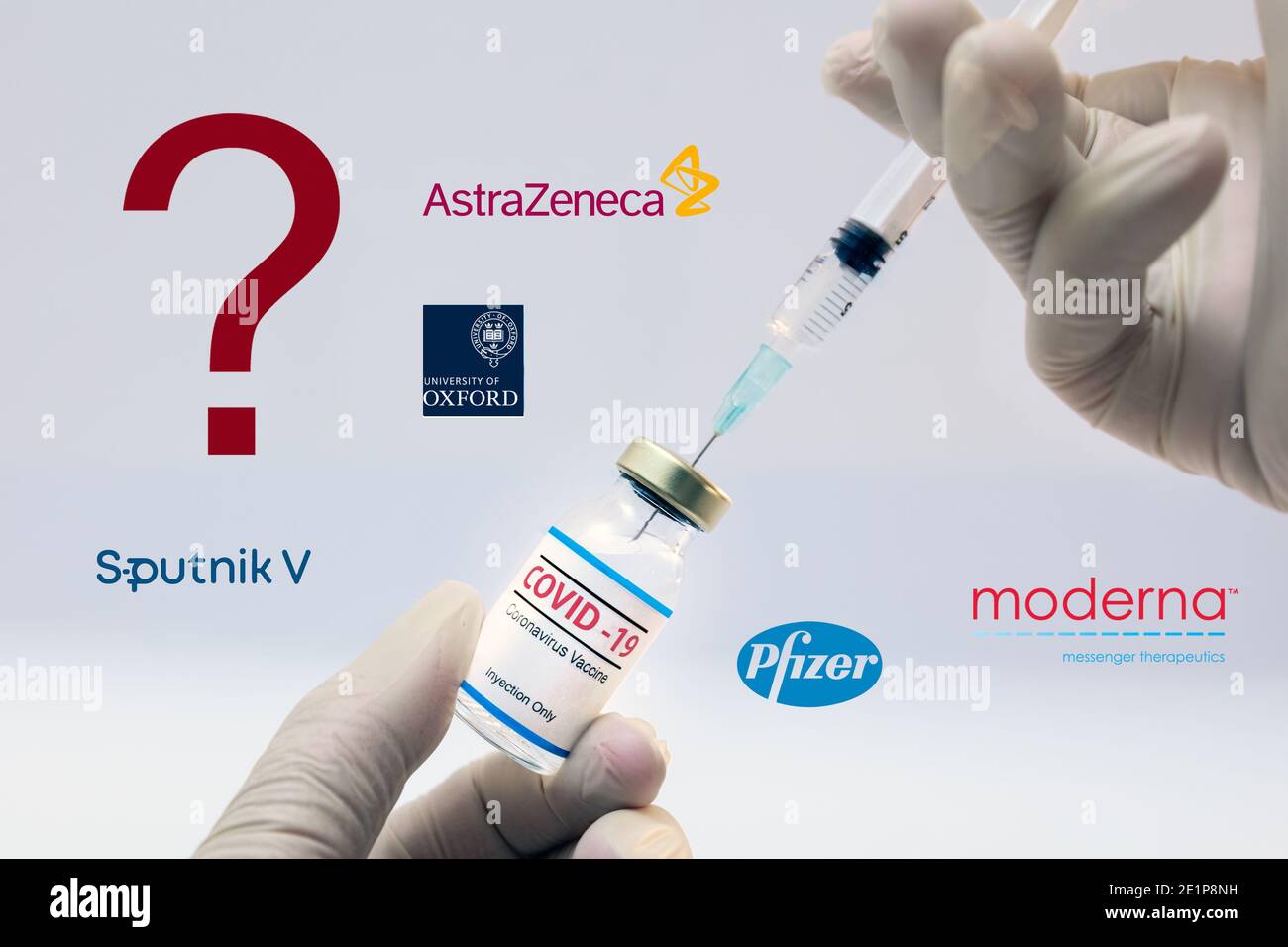 Athens, Greece - Januar06, 2021: Dr. hands holding a bottle of coronavirus vaccine with a question sign and the Pfizer, Sputnik V, Moderna, Astra Zene Stock Photo