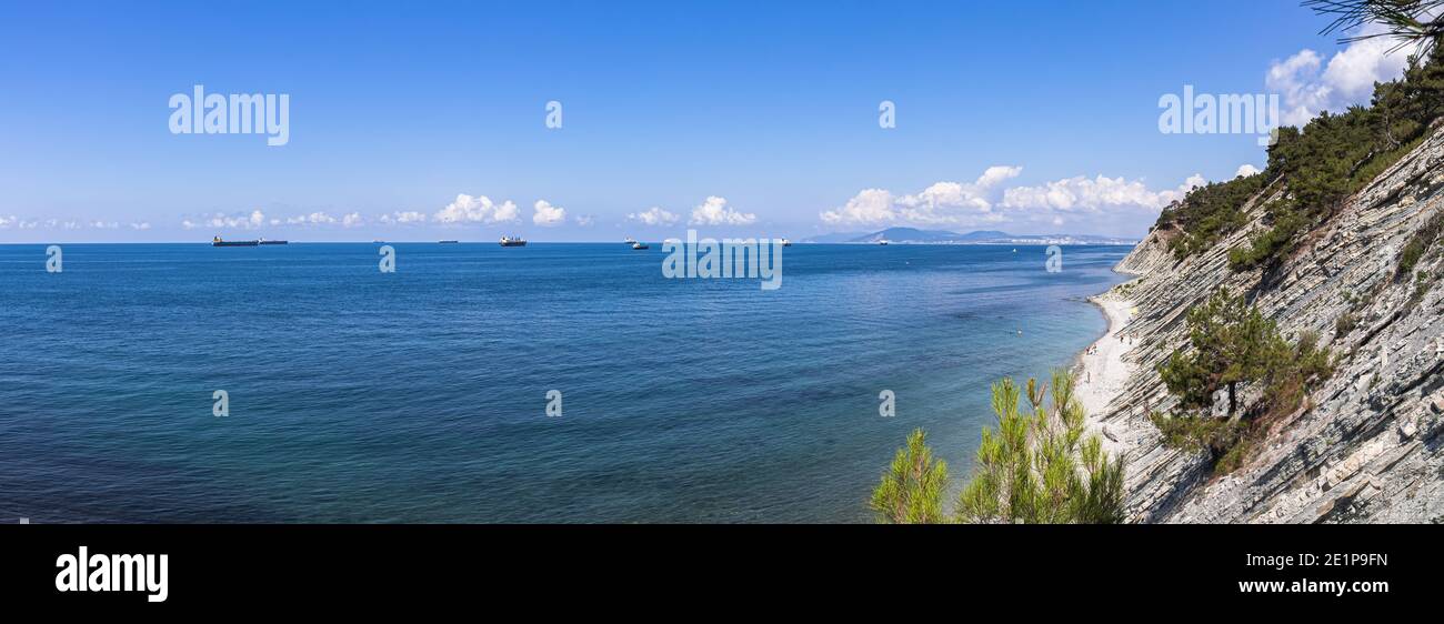 Panorama of the sea coast and wild beach at the foot of the rocks in the vicinity of the resort of Gelendzhik Stock Photo