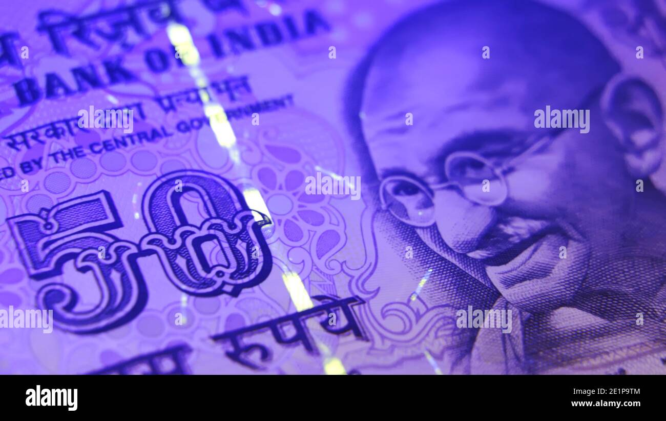 Warsaw, Poland 01.01.2021 Indian Rupees paper banknotes being counted. The Gandhi Series of banknotes issued by the Reserve Bank of India (RBI) extreme close up shot . High quality photo Stock Photo