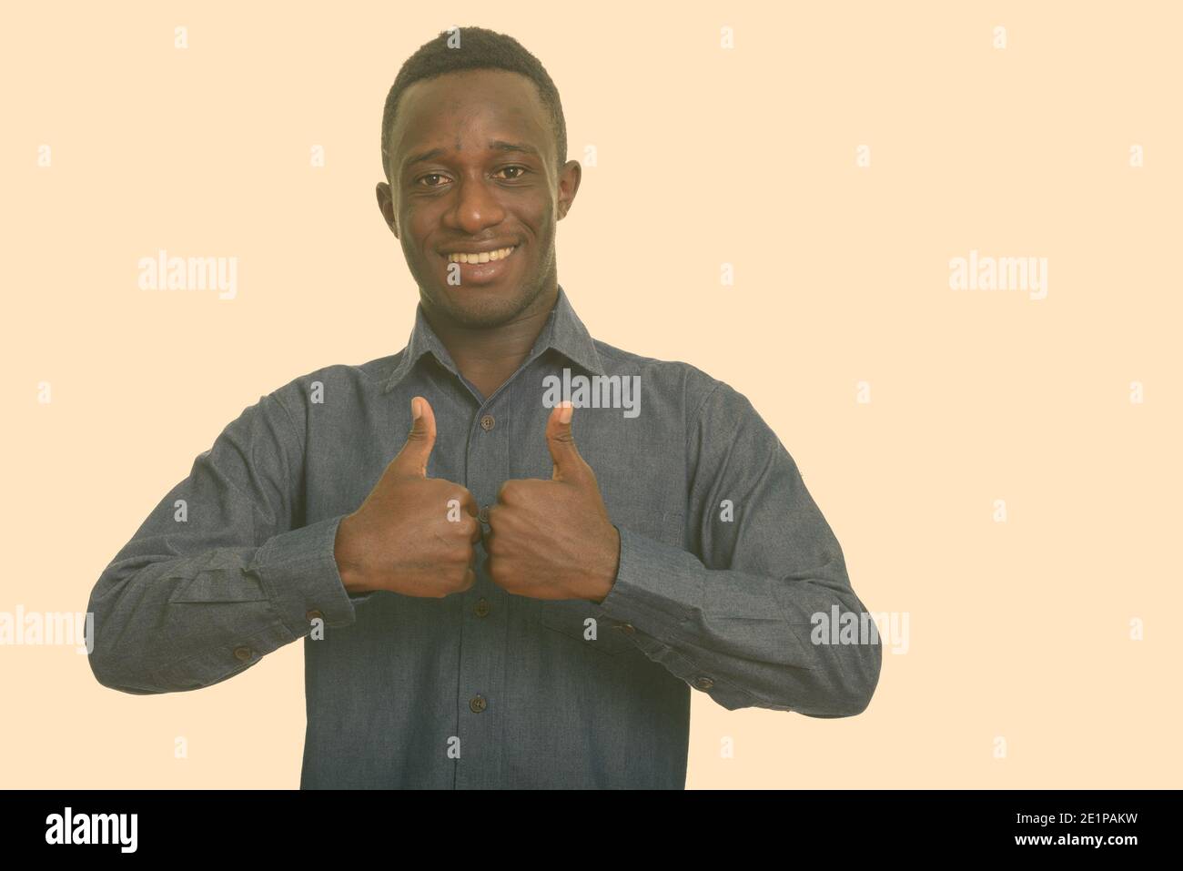 Young happy African man smiling giving thumbs up Stock Photo - Alamy