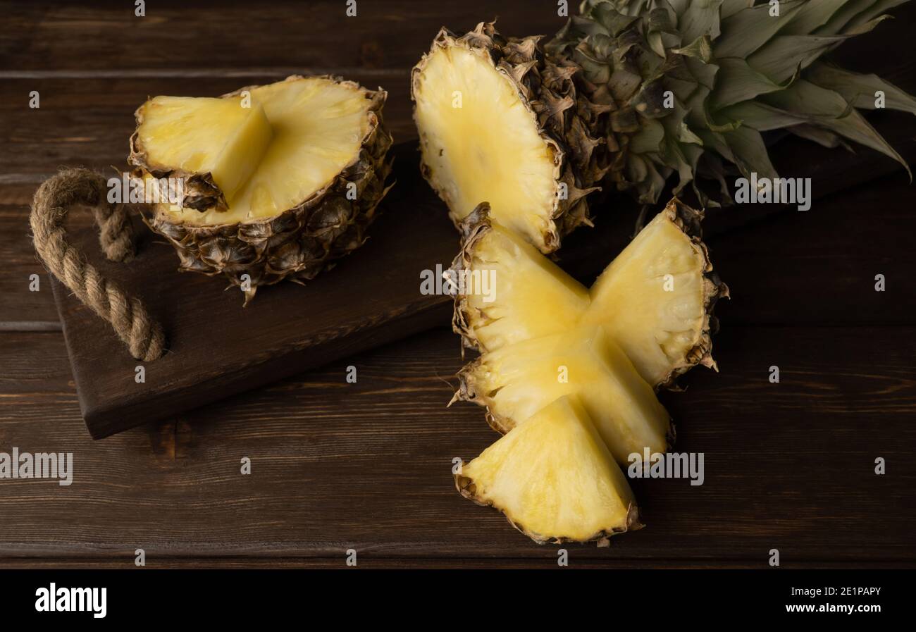 pineapple on a wooden background. selective focus. Sliced fresh fruit Stock Photo