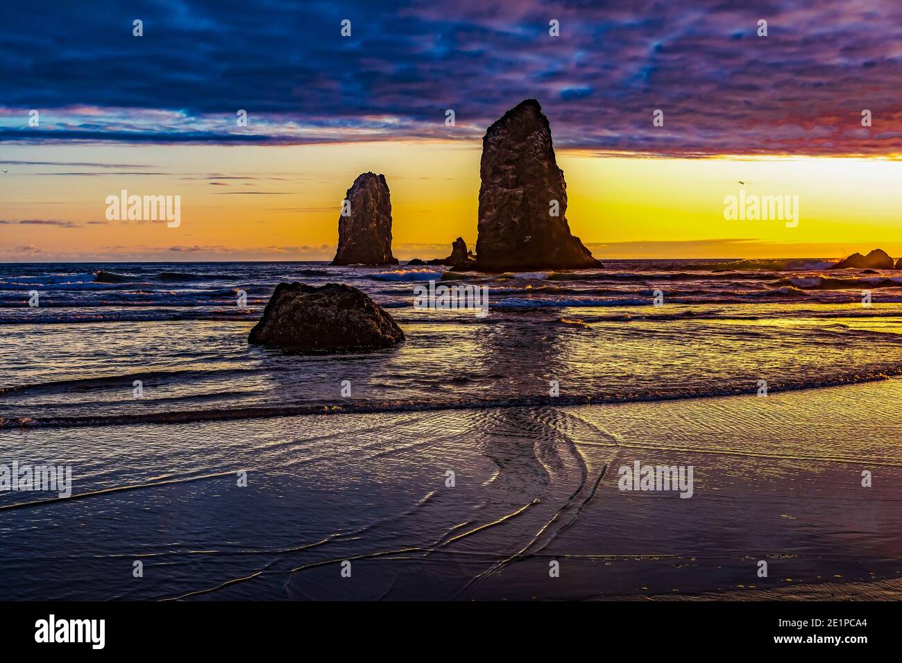 Colorful Sunset Sea Stacks Canon Beach Clatsap County Oregon.  Orginally discovered by Clark of Lewis Clark in 1805 Stock Photo