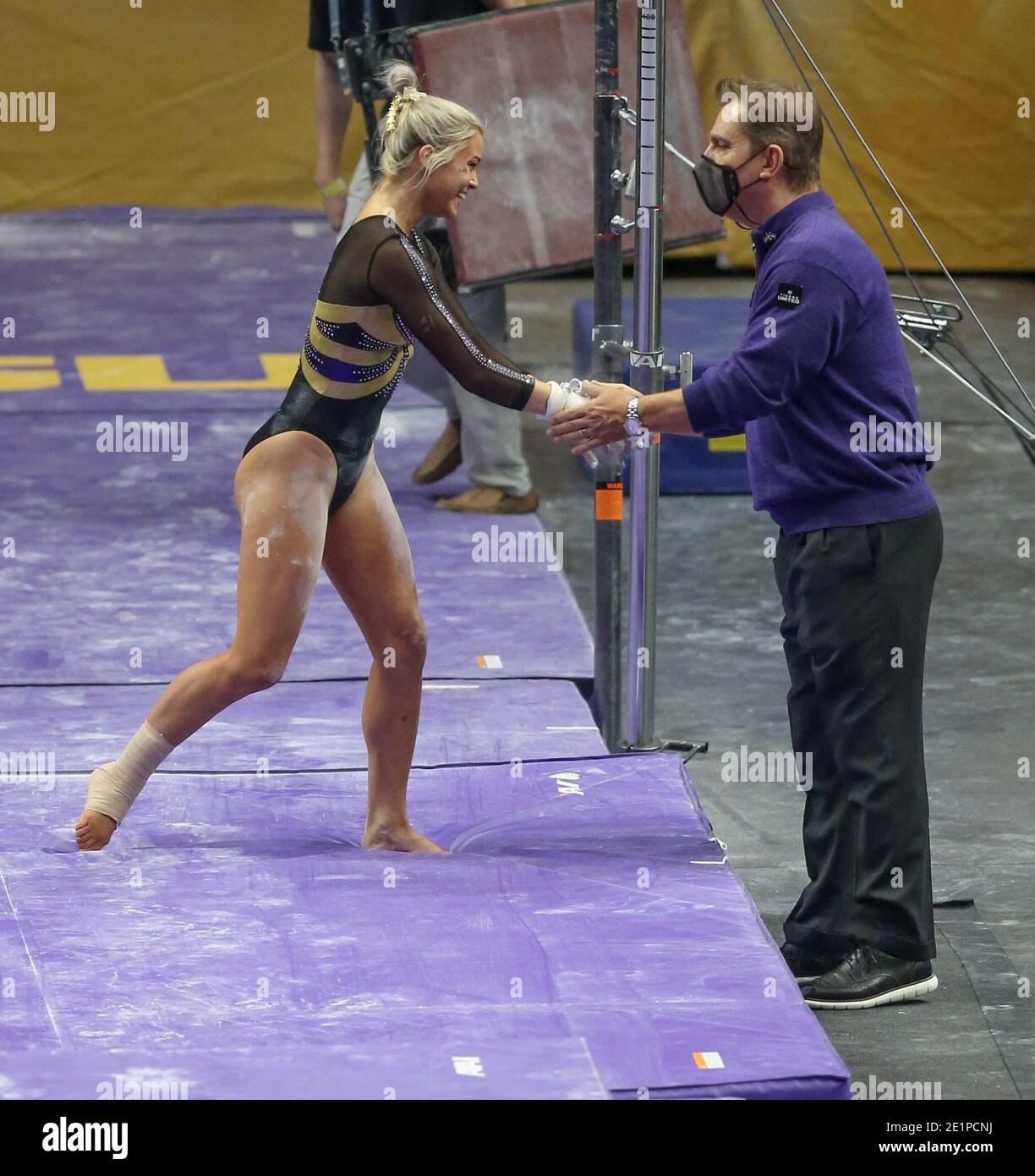 Baton Rouge, LA, USA. 8th Jan, 2021. LSU Head Coach Jay Clark congratulates Olivia Dunne after her bar routine during NCAA Gymnastics action between the Arkansas Razorbacks and the LSU Tigers at Baton Rouge, LA, USA. 8th Jan, 2021. LSU Head Coach Jay Clark congratulates Olivia Dunne after her bar routine during NCAA Gymnastics action between the Arkansas Razorbacks and the LSU Tigers at