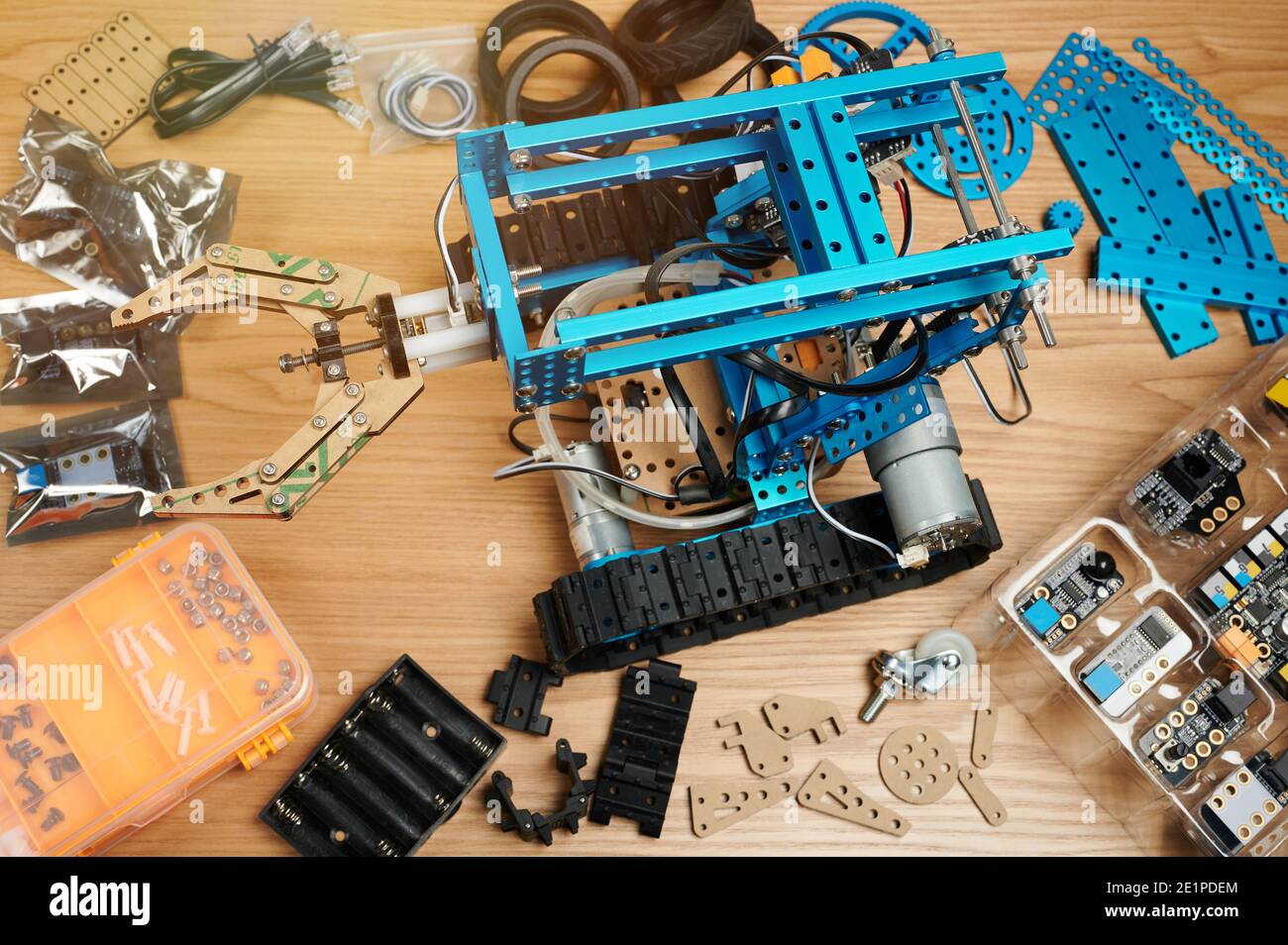 Programming classes theme. Robotic school background. Robot on table with parts around Stock Photo