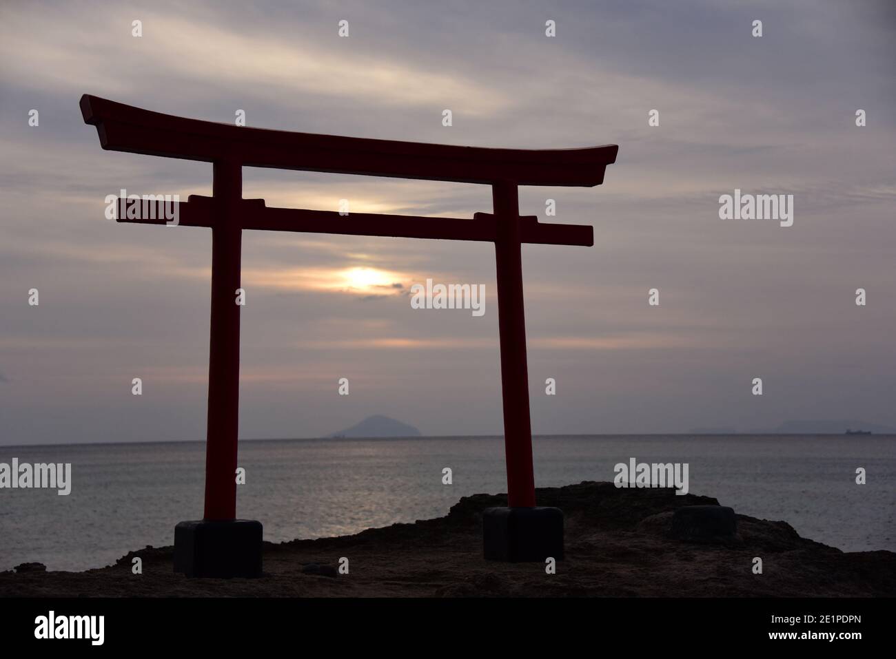 Japanese torii temple sunrise on pacific Stock Photo