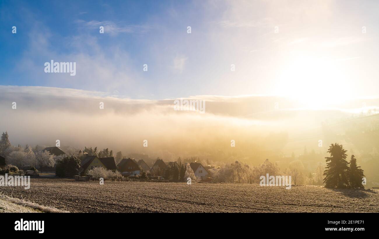 Foggy view - Seiffen in Winter Saxony Germany ore mountains. Stock Photo