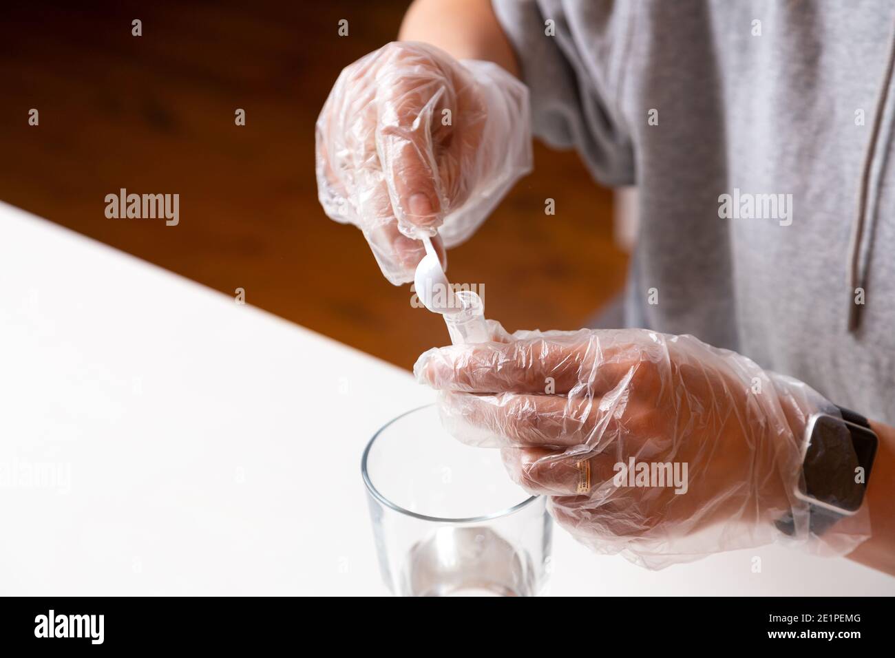Chemistry education and training concept. Close-up woman pours a ...