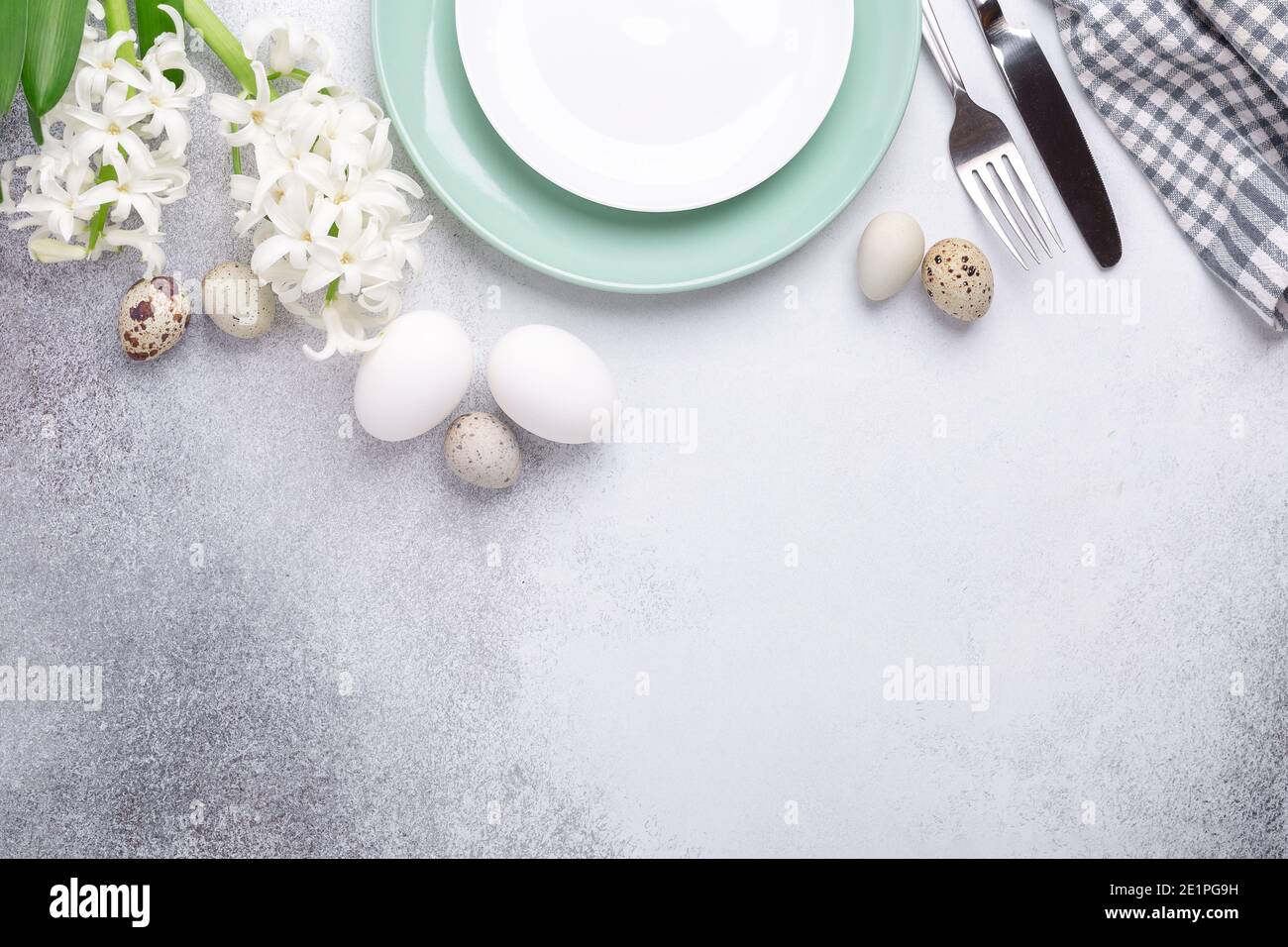 Light Easter composition. Green mint plate, easter eggs, pink and white hyacinth on stone background. Easter concept - Image Stock Photo