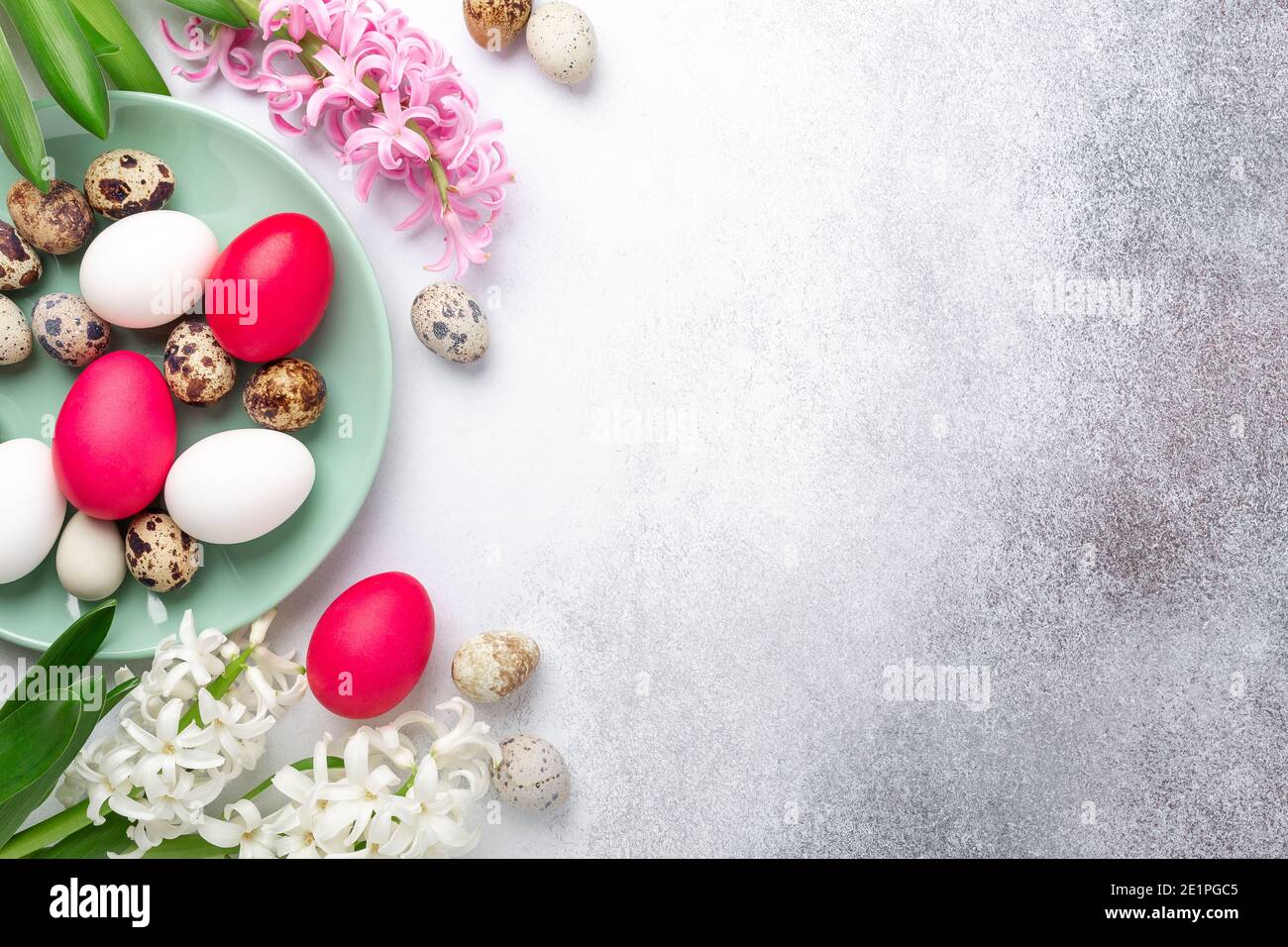Green mint plate with easter eggs and hyacinths on stone background. Easter concept. Flat lay - Image Stock Photo