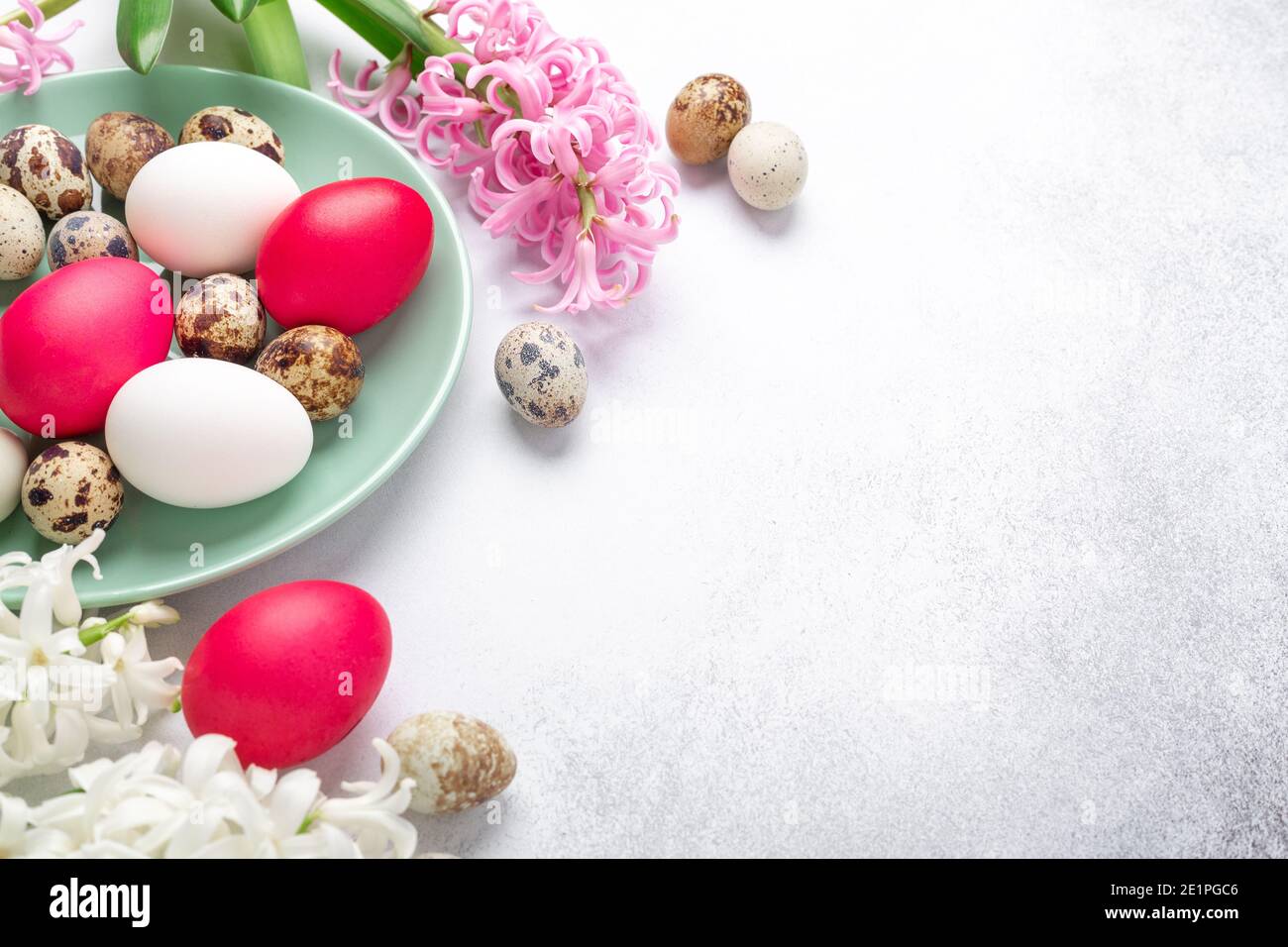 Green mint plate with easter eggs and hyacinths on stone background. Easter concept - Image Stock Photo