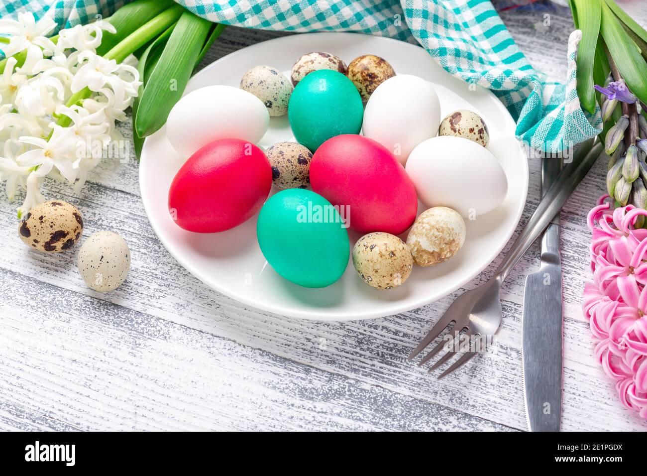 Easter eggs in white plate on wooden background. Easter concept - Image Stock Photo