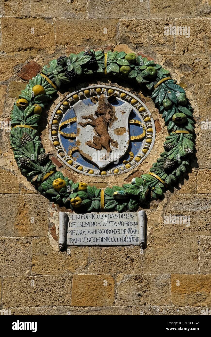 Volterra, Tuscany, Italy: enamelled terracotta medallions or plaques bearing the arms of Florentine commissioners, such as this example of 1489 for Piero di Niccolò d'Andrea del Benino, stud the Piazza dei Priori façade of Palazzo Pretorio, the oldest town hall in Tuscany.  The building, founded in 1208, was once Volterra’s seat of civic, judicial and military power.  The plaques are a reminder of how, in the late 1400s, Florence’s Medici rulers ruthlessly crushed any lingering hopes still held by Volterra that it could retain a degree of independence. Stock Photo