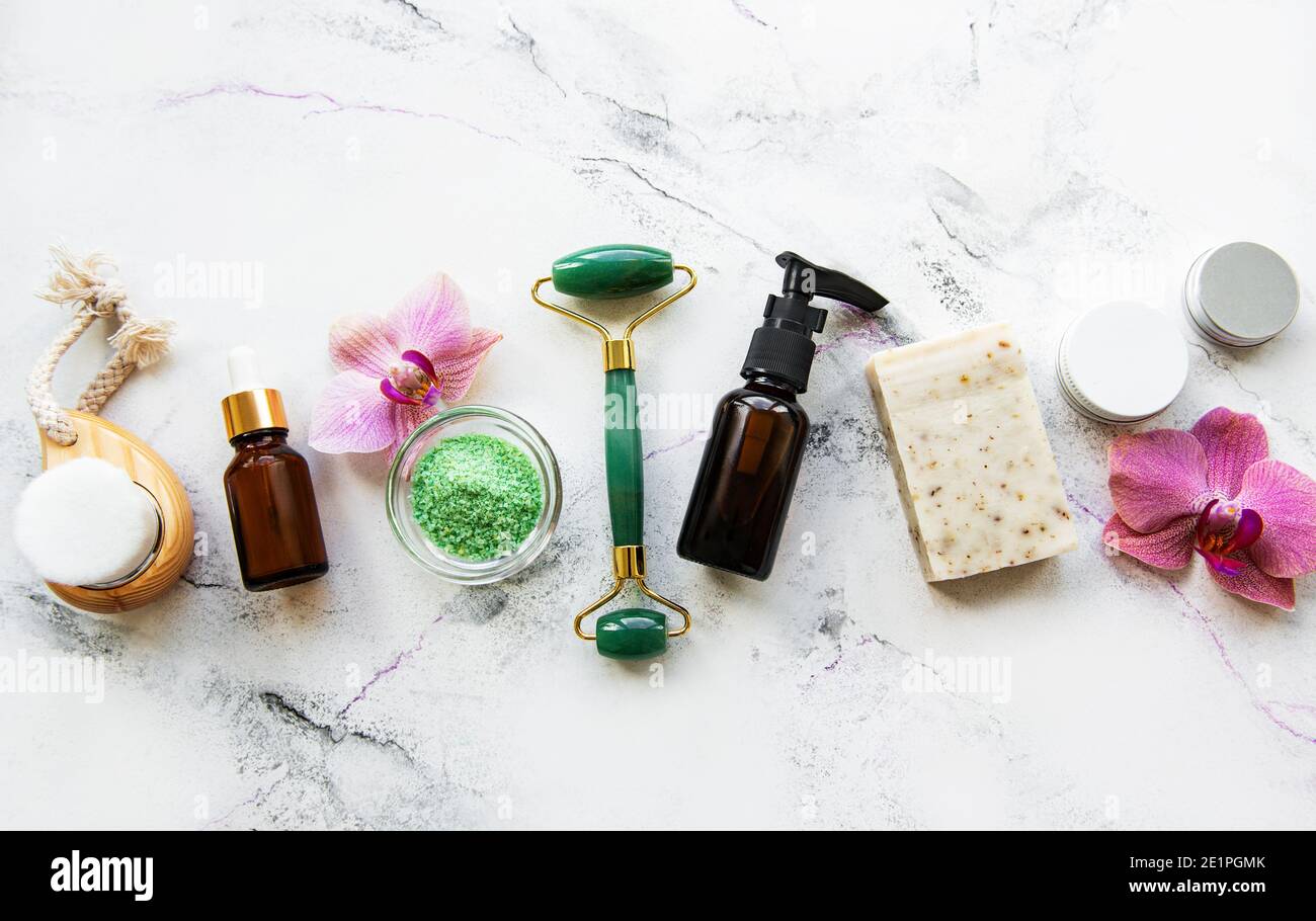 Zero waste bathroom accessories and jade roller on a marble background. Flat lay Stock Photo