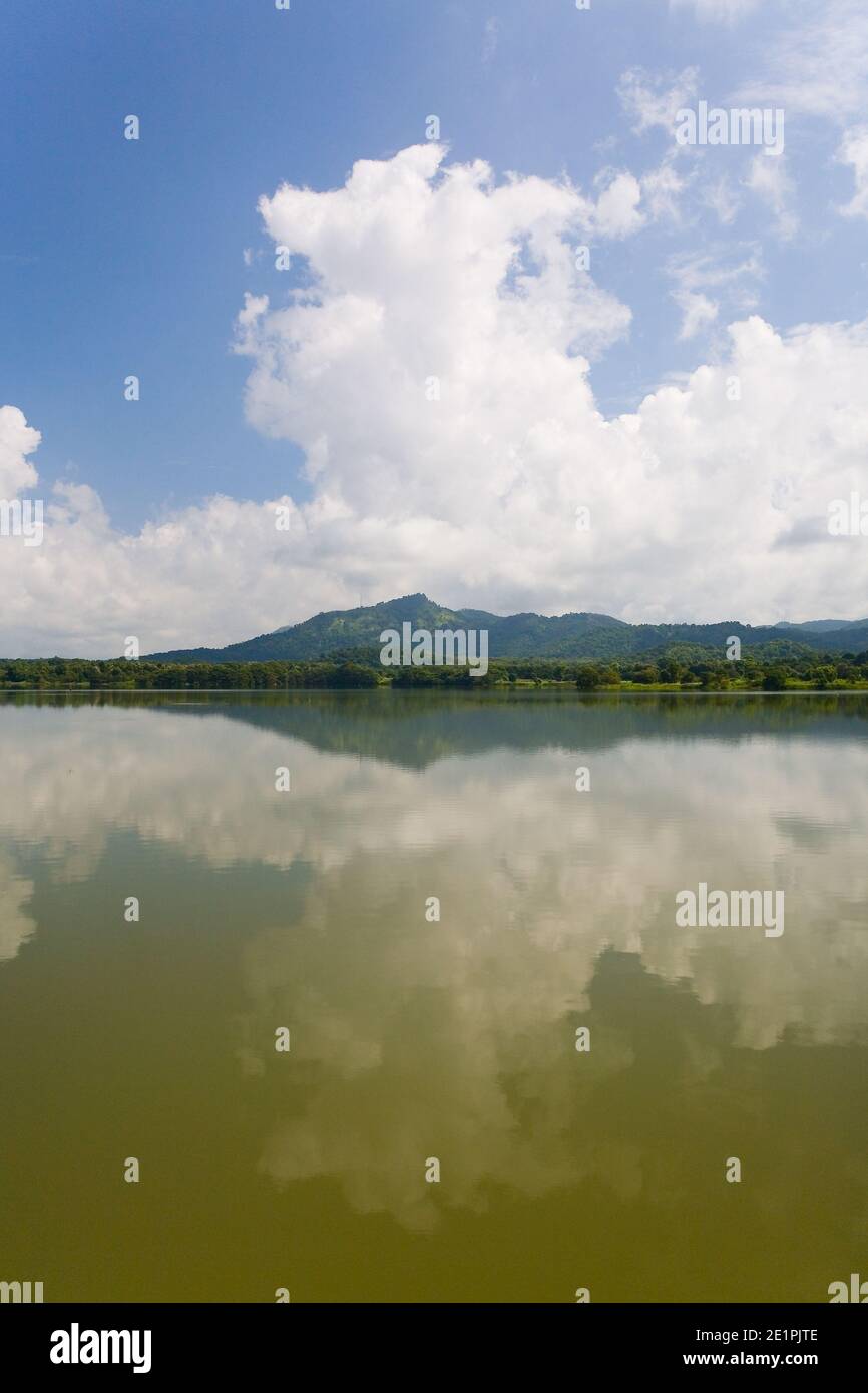 Mountains and a cloud in the sky are reflected in the lake. Beautiful landscape of Sri Lanka. Stock Photo