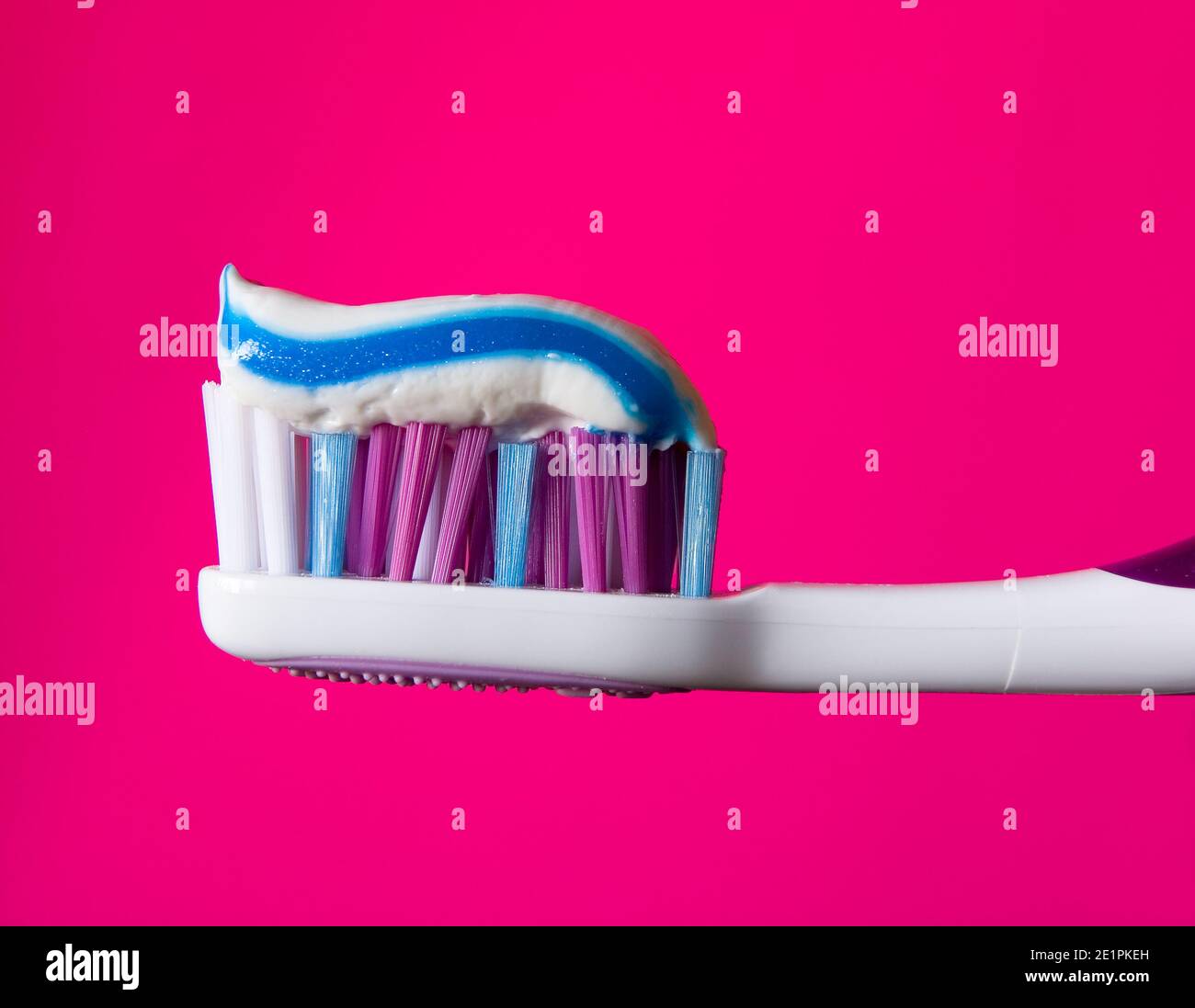Beautiful multi-colored toothbrush with toothpaste close-up. Hygiene products. Stock Photo