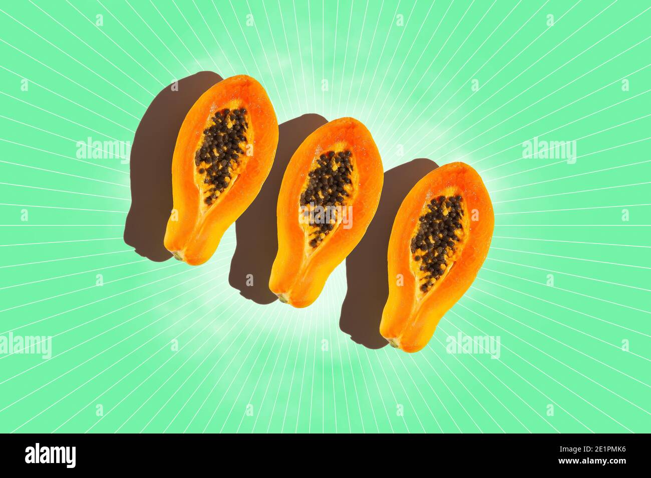 Three slices of papaya  on green background. Top view. Stock Photo