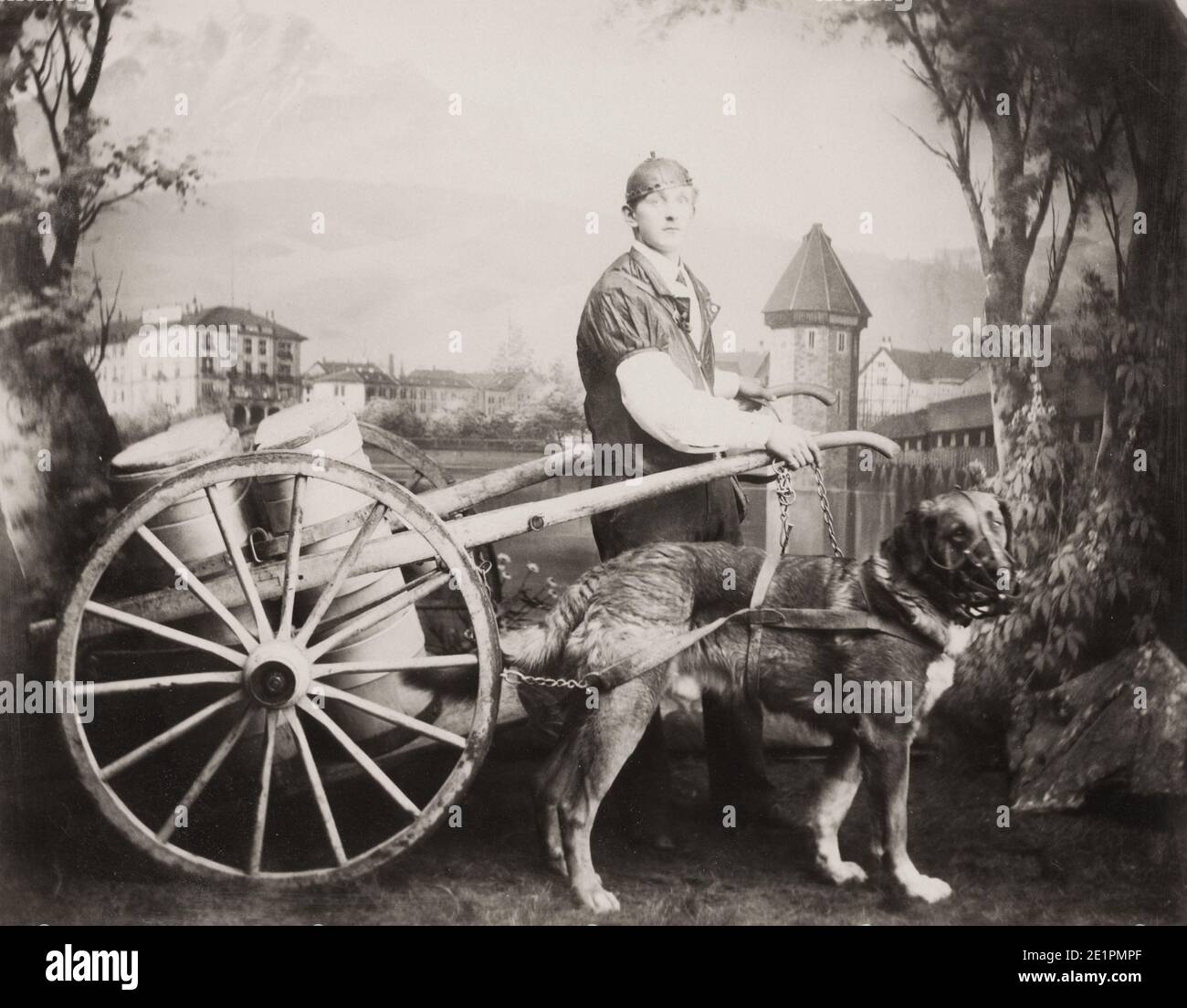 Vintage 19th century photograph: Belgium, c.1890's. Dog milk cart with handler, dog muzzled. Stock Photo