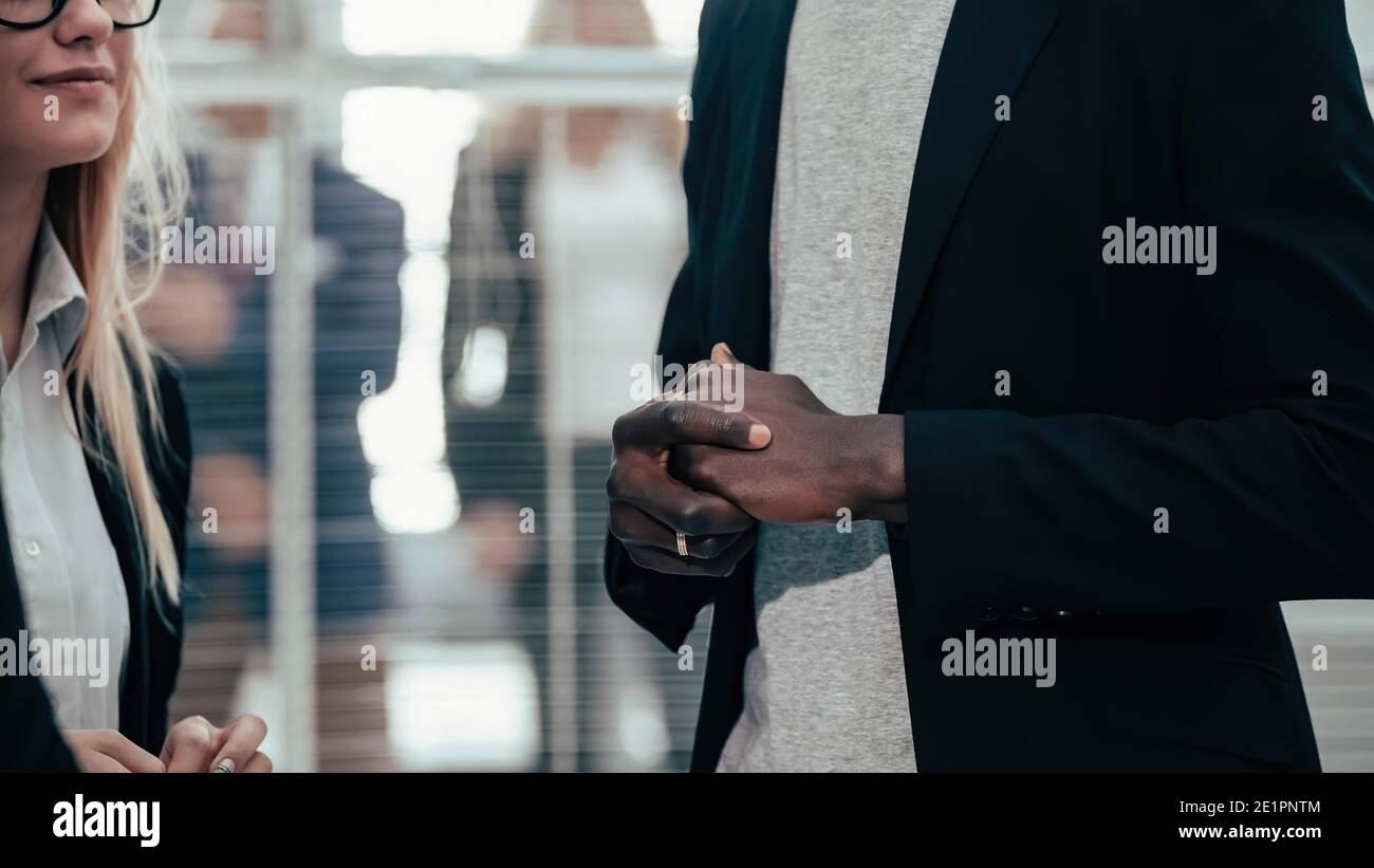 business man talking to his colleagues standing in the office Stock Photo