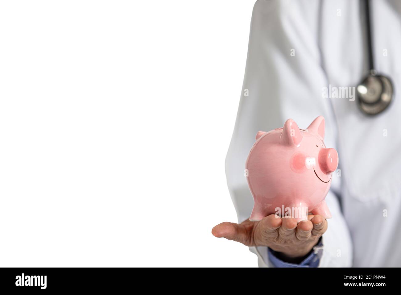 A male doctor in white hospital gown holding a pink piggy bank in his hand. Hospital expense concept. Stock Photo