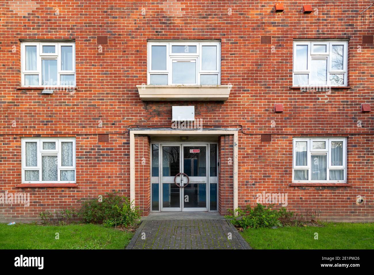 The entrance of a typical British brick block of flats Stock Photo Alamy