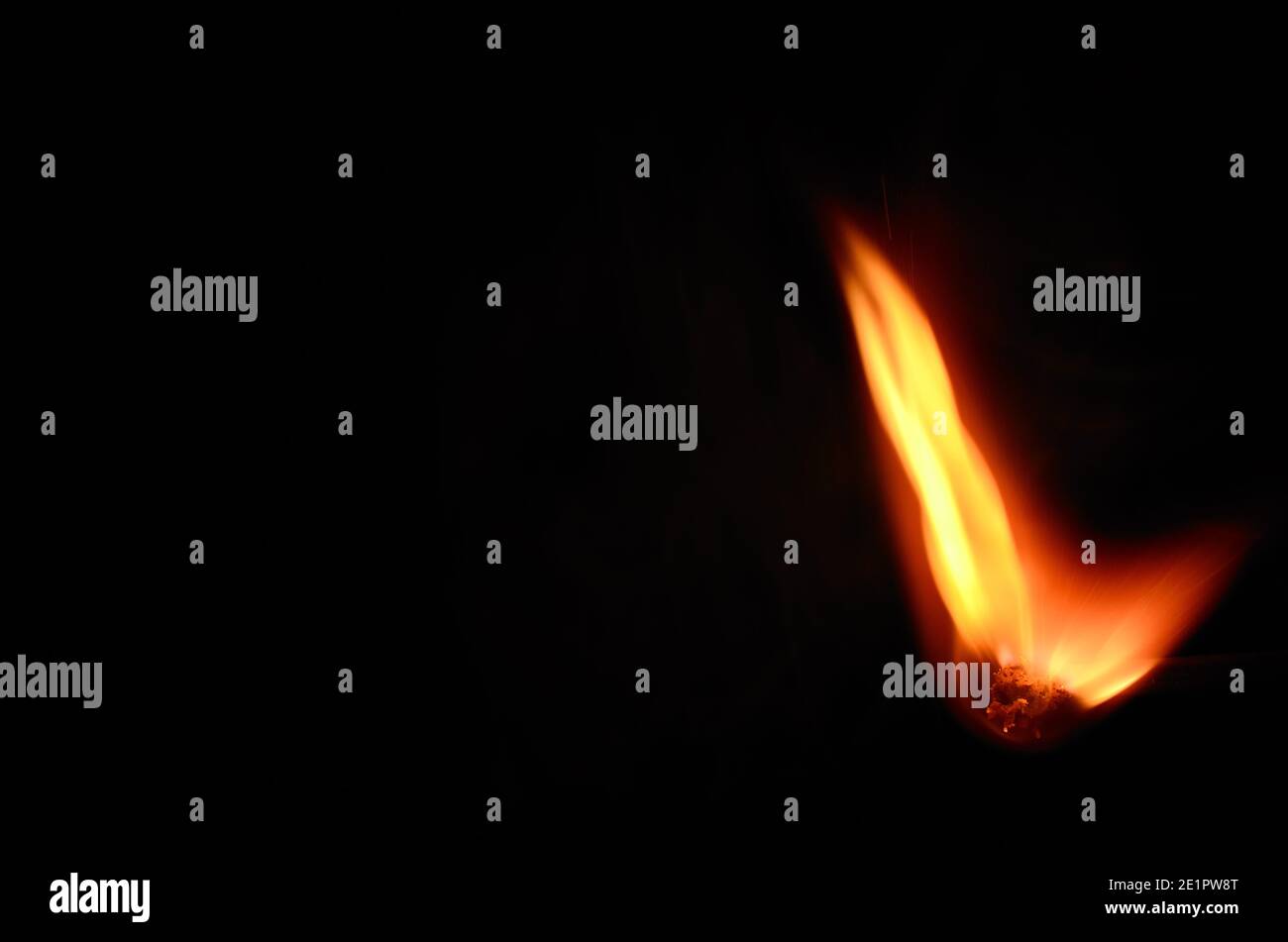 match with hot bright flame on black background Stock Photo