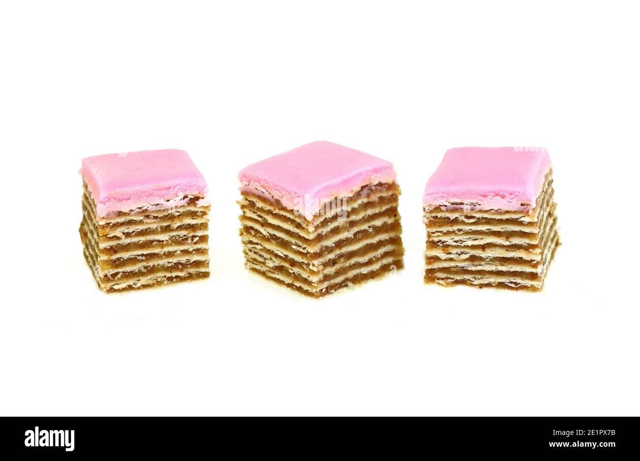 Small piece of meny layers cake with cream and strawberry frosting. Pink  decoration on the top. White background Stock Photo