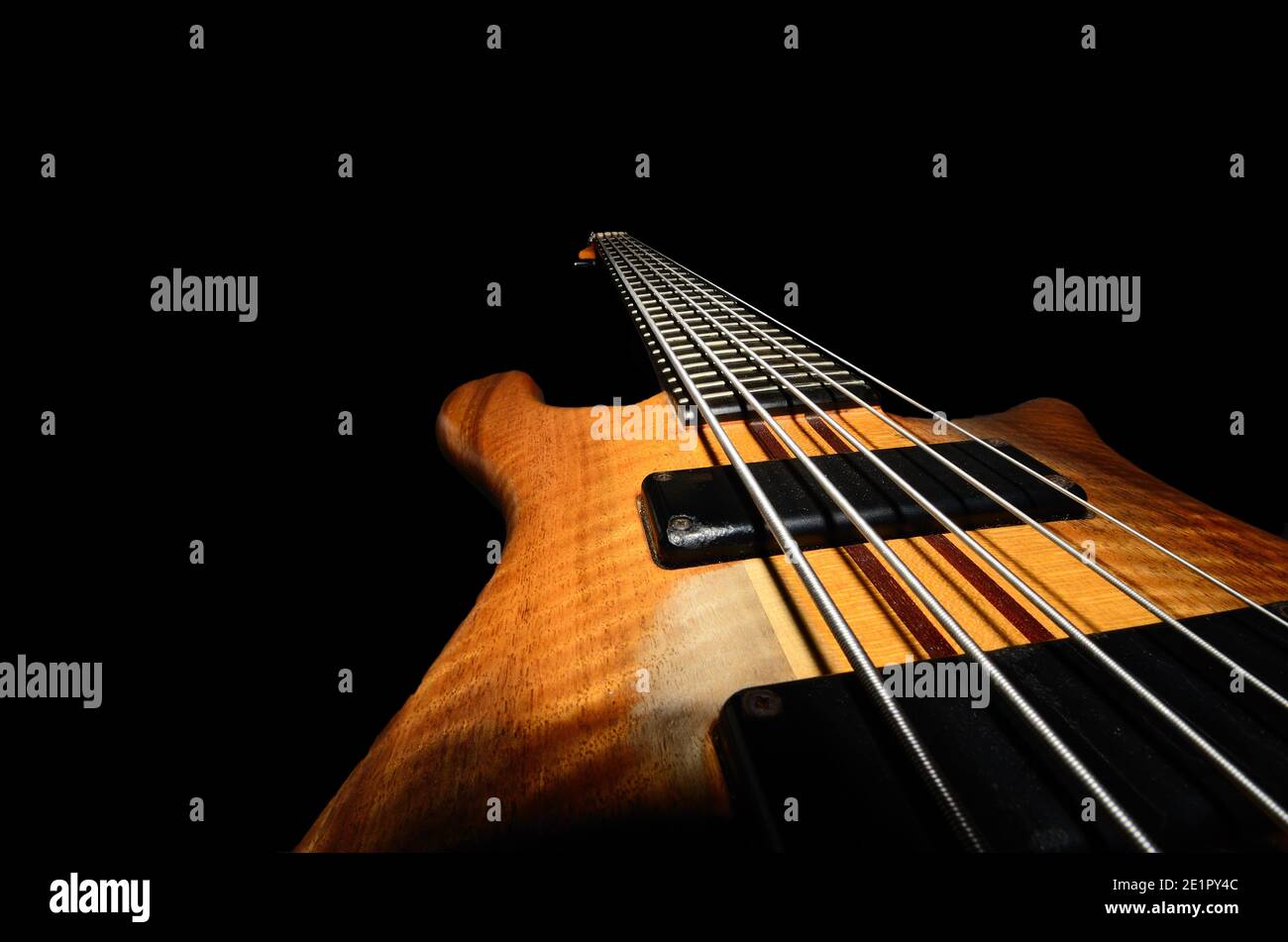 bass guitar strings with wooden close up black background Stock Photo