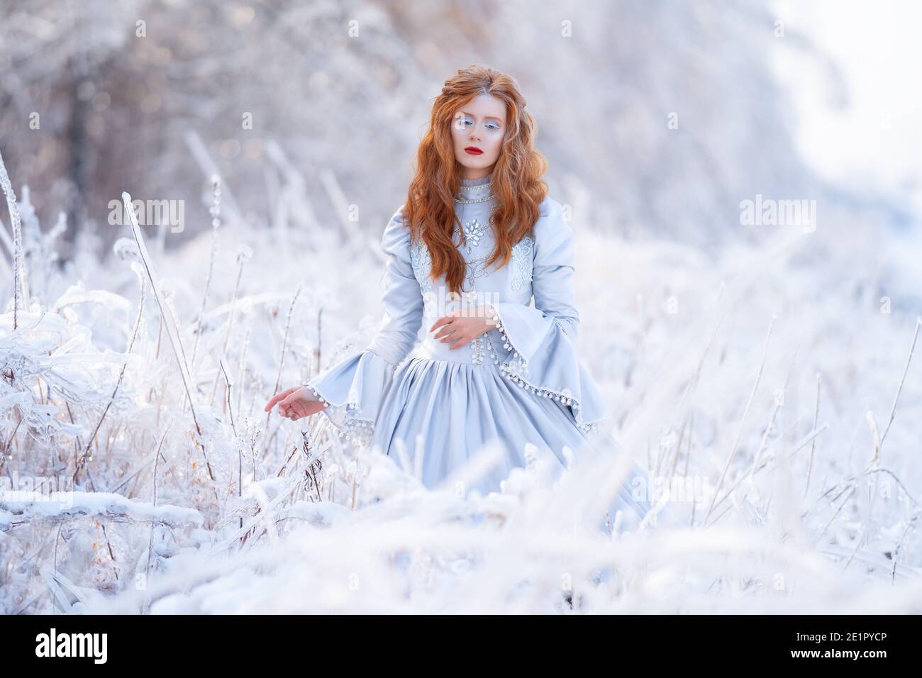 Young Redhead Girl In Flowing Red Dress In Forest With Snowfall. Photograph  by Cavan Images - Fine Art America