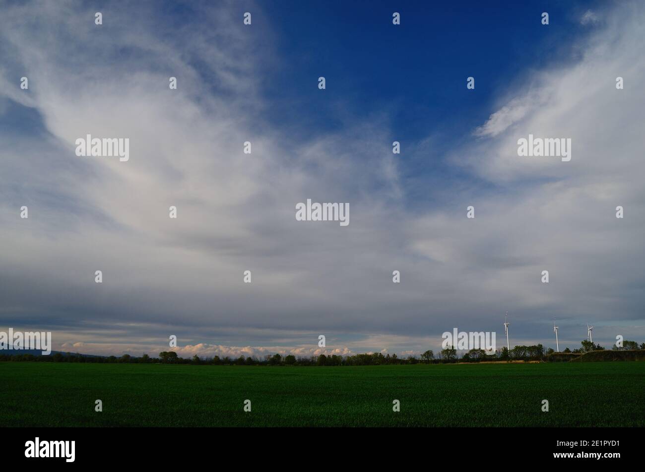 green field and blue sky with clouds Stock Photo - Alamy