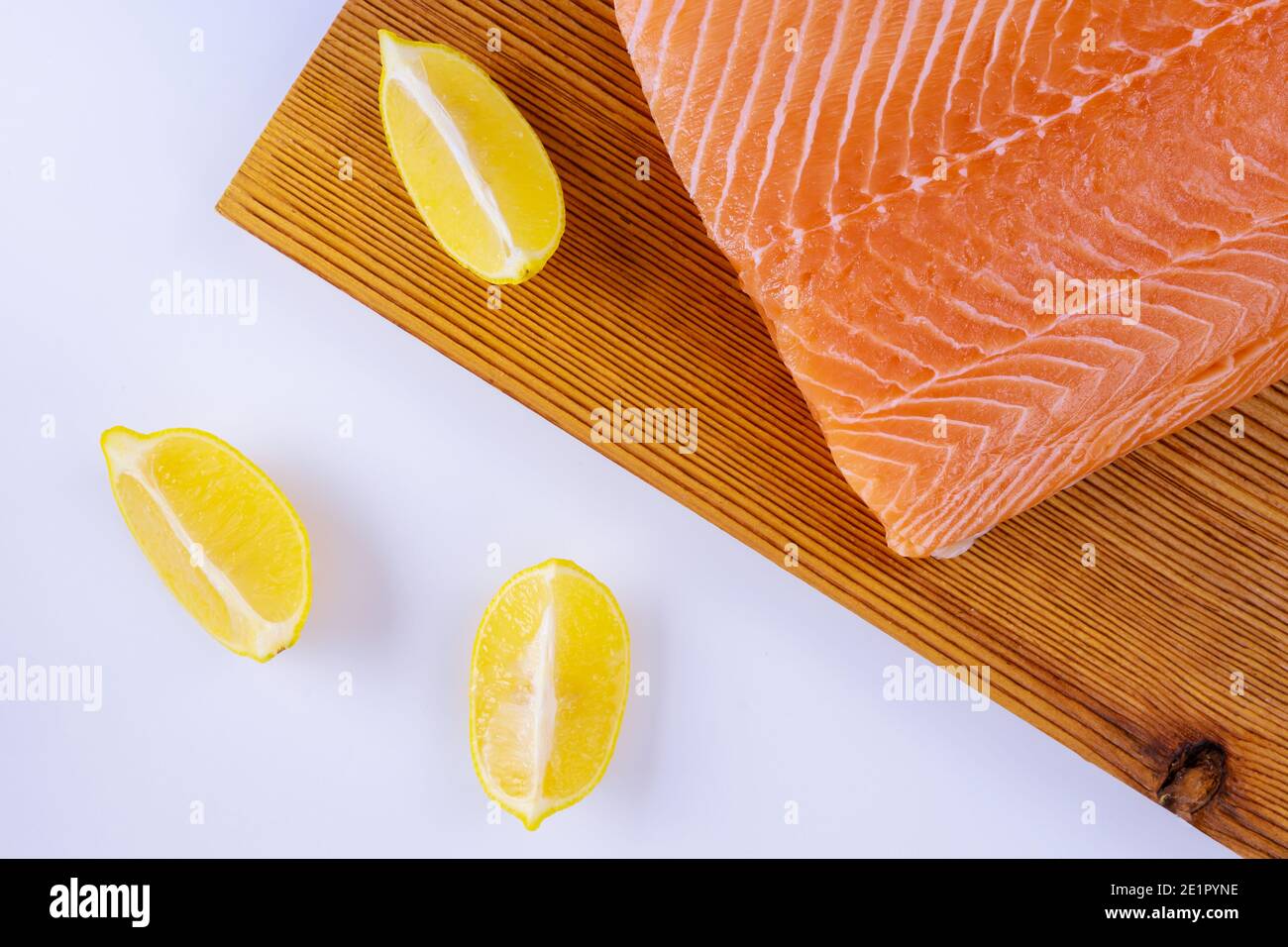 Raw fillets salmon in wooden cutting board on white background Stock ...