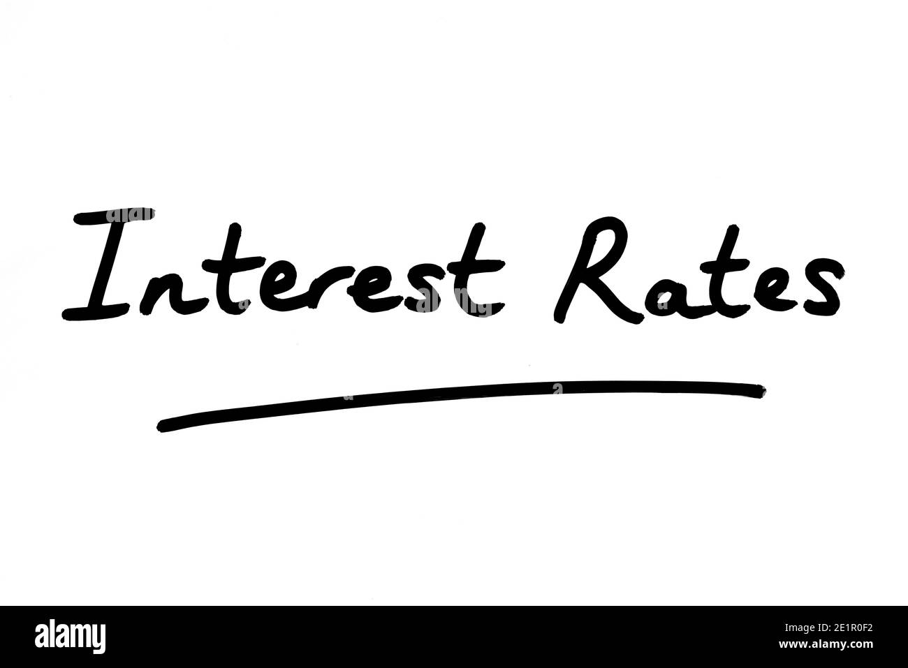 Interest Rates, handwritten on a white background. Stock Photo
