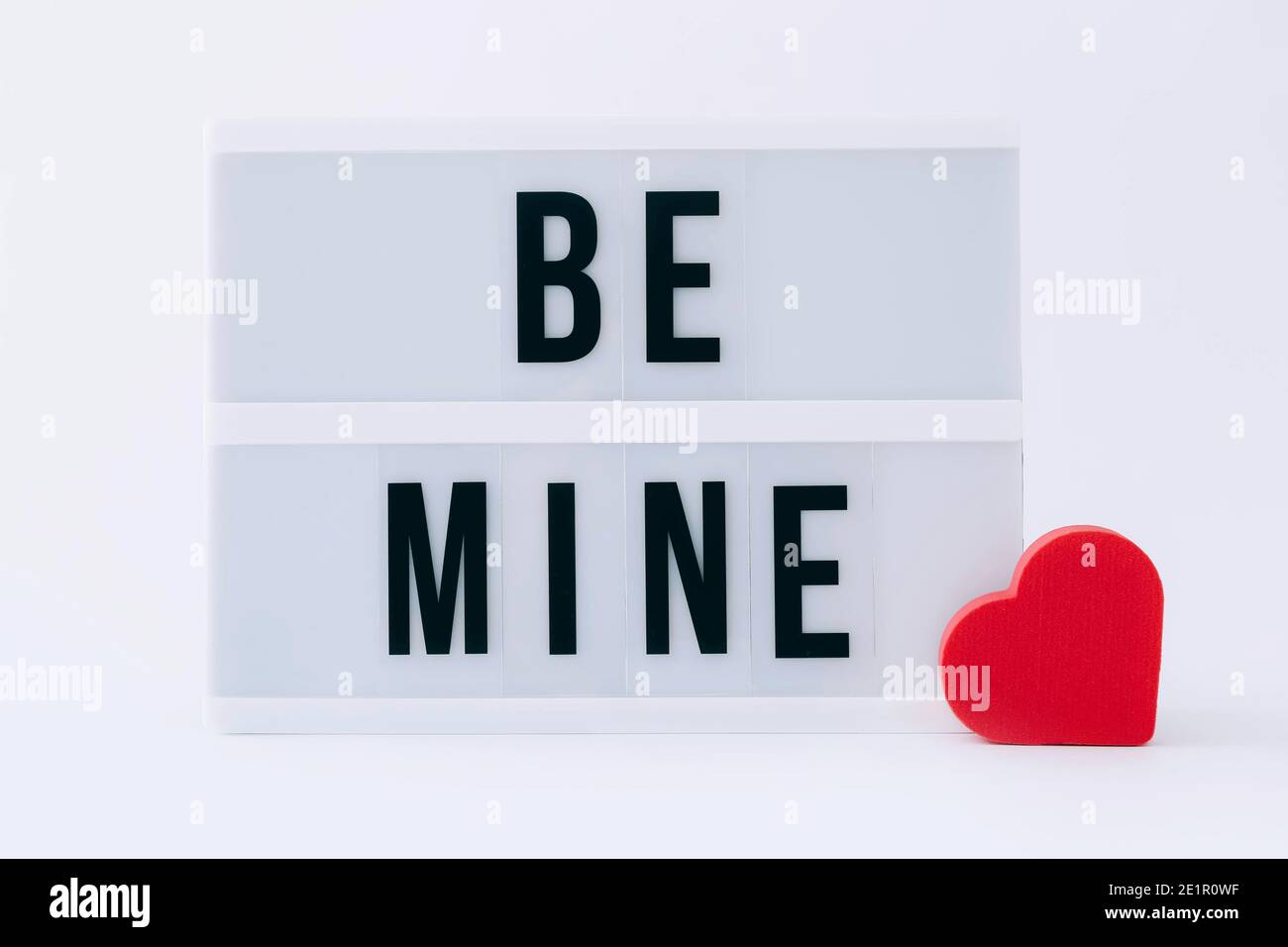 Be mine lightbox message with red heart sponge on a light background Stock Photo