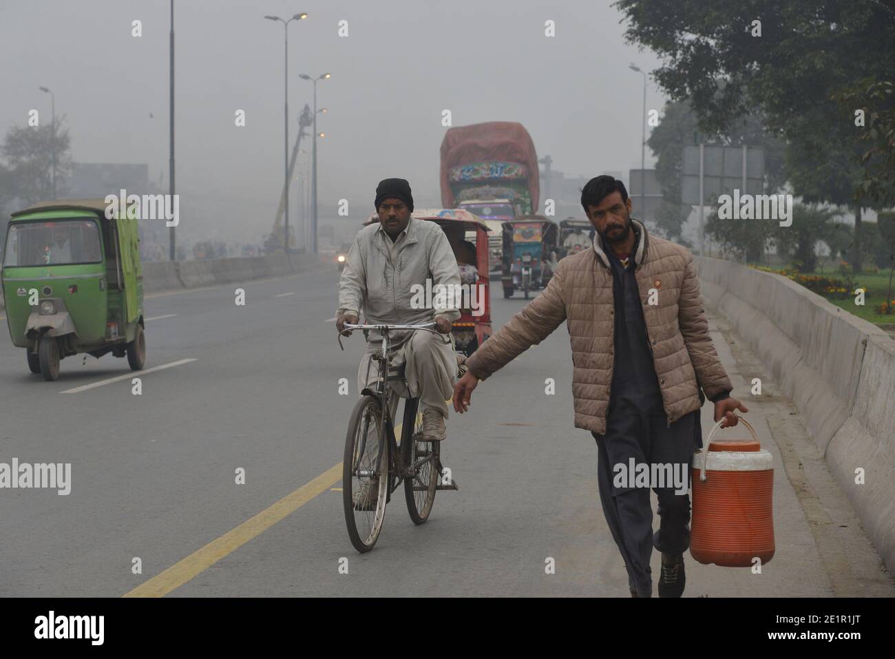 Lahore, Pakistan. 09th Jan, 2021. Pakistani commuters make their way