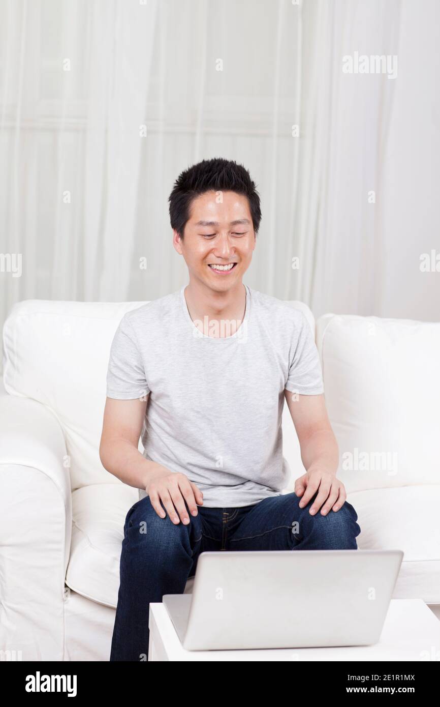 Buff At Computer Cheerful businessman using a laptop computer in sofa high quality photo ...