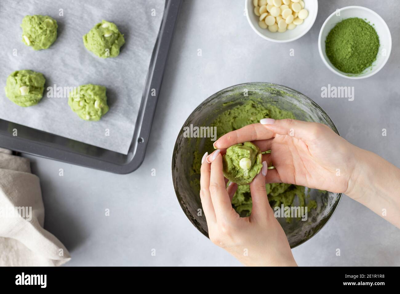 female hands making matcha green tea cookie Stock Photo