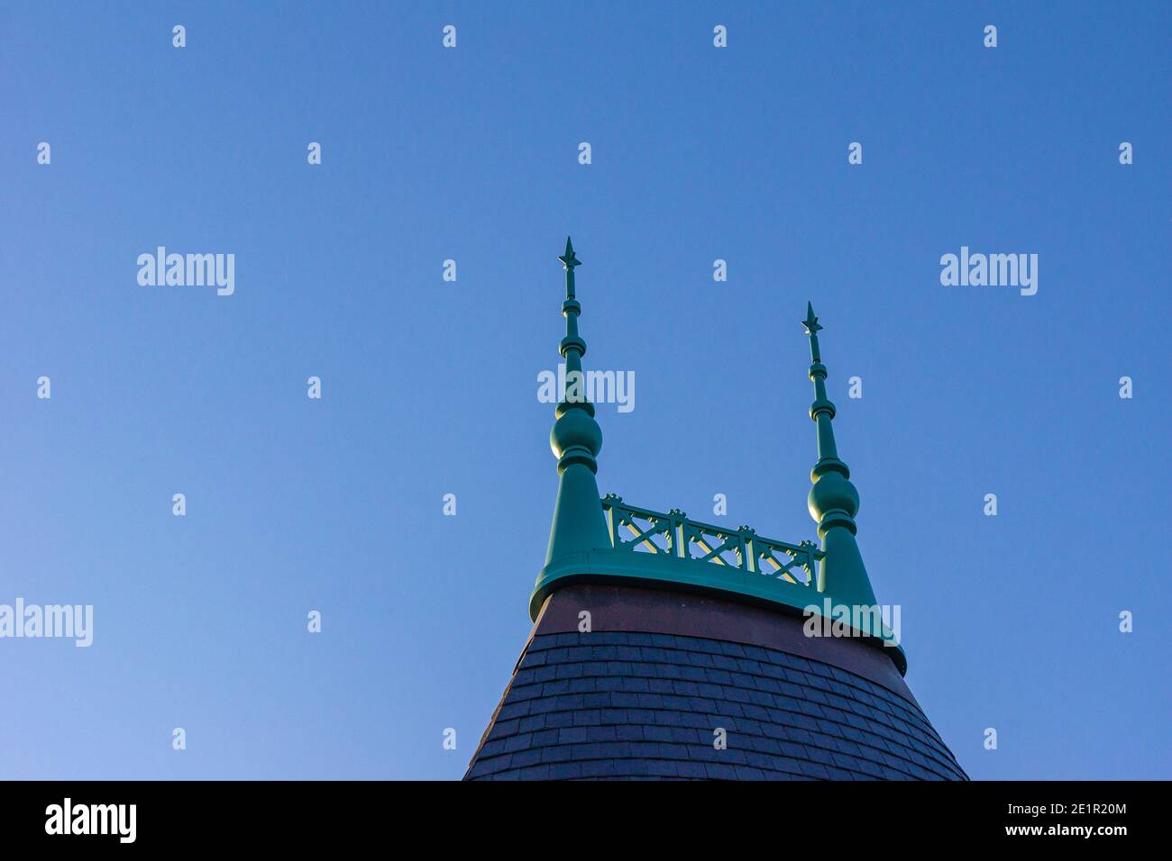 roof top decorated with a lattice ridge with two spiers or lightning rods or finials, selective focus Stock Photo