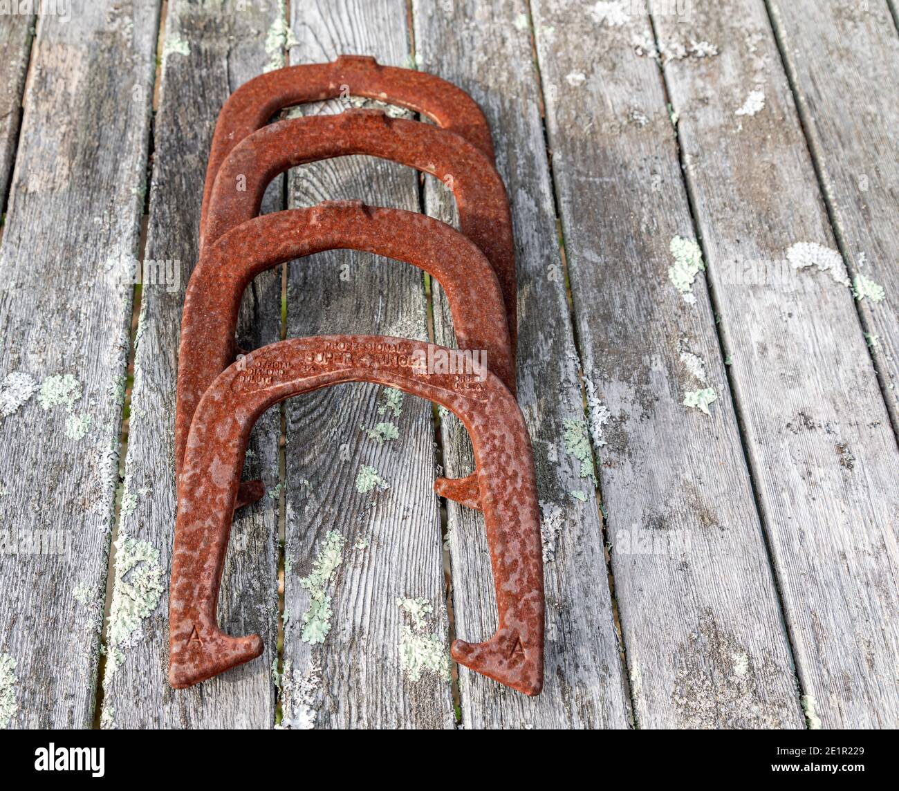 Set of four rusted metal horse shoes Stock Photo