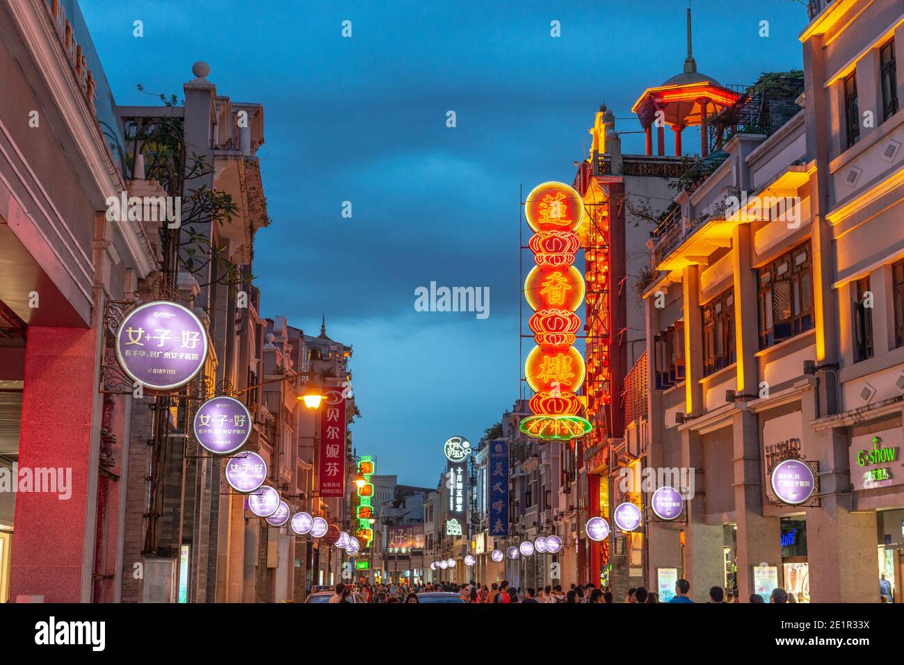 GUANGZHOU, CHINA - MAY 25, 2014: Pedestrians pass through Shangxiajiu Pedestrian Street. The street is the main shopping district of the city and a ma Stock Photo