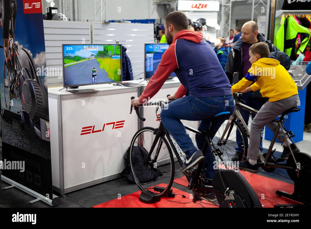 Ukraine, Kiev - February 20, 2020: Cycling simulator. Indoor computer game for cycling at home. Exercise bike. Exhibition for sale. Exercise bikes for Stock Photo