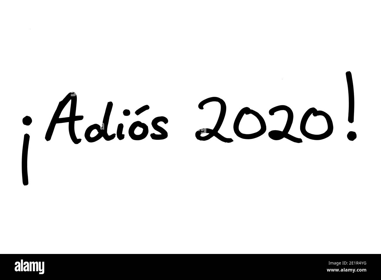 Adios 2020! - meaning Goodbye 2020! in the Spanish language - handwritten on a white background. Stock Photo