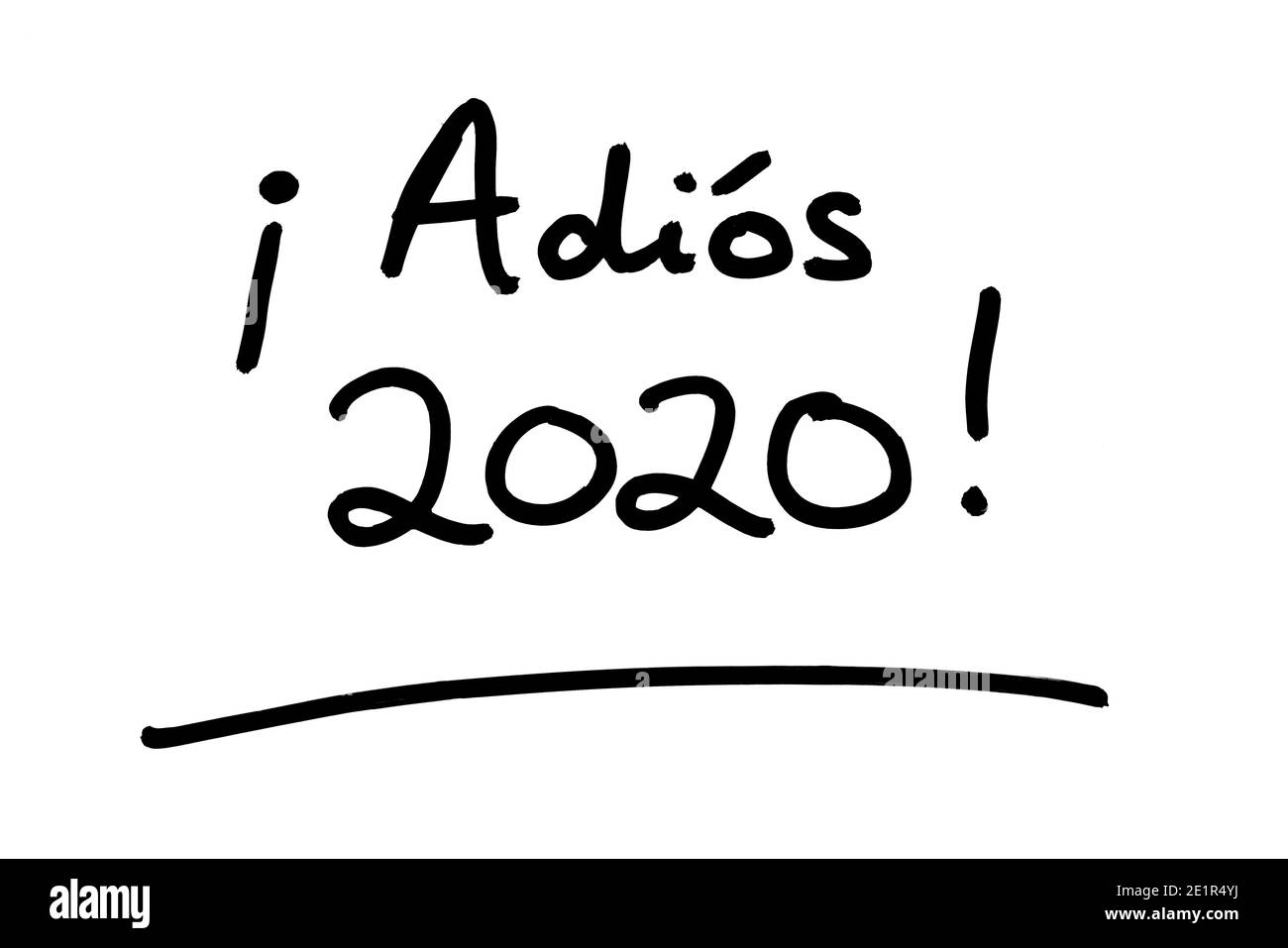 Adios 2020! - meaning Goodbye 2020! in the Spanish language - handwritten on a white background. Stock Photo