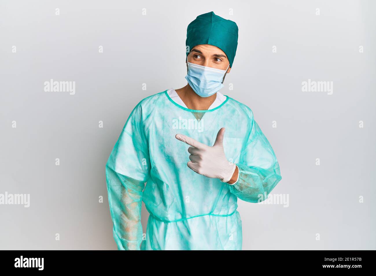 Young handsome man wearing surgeon uniform and medical mask cheerful ...