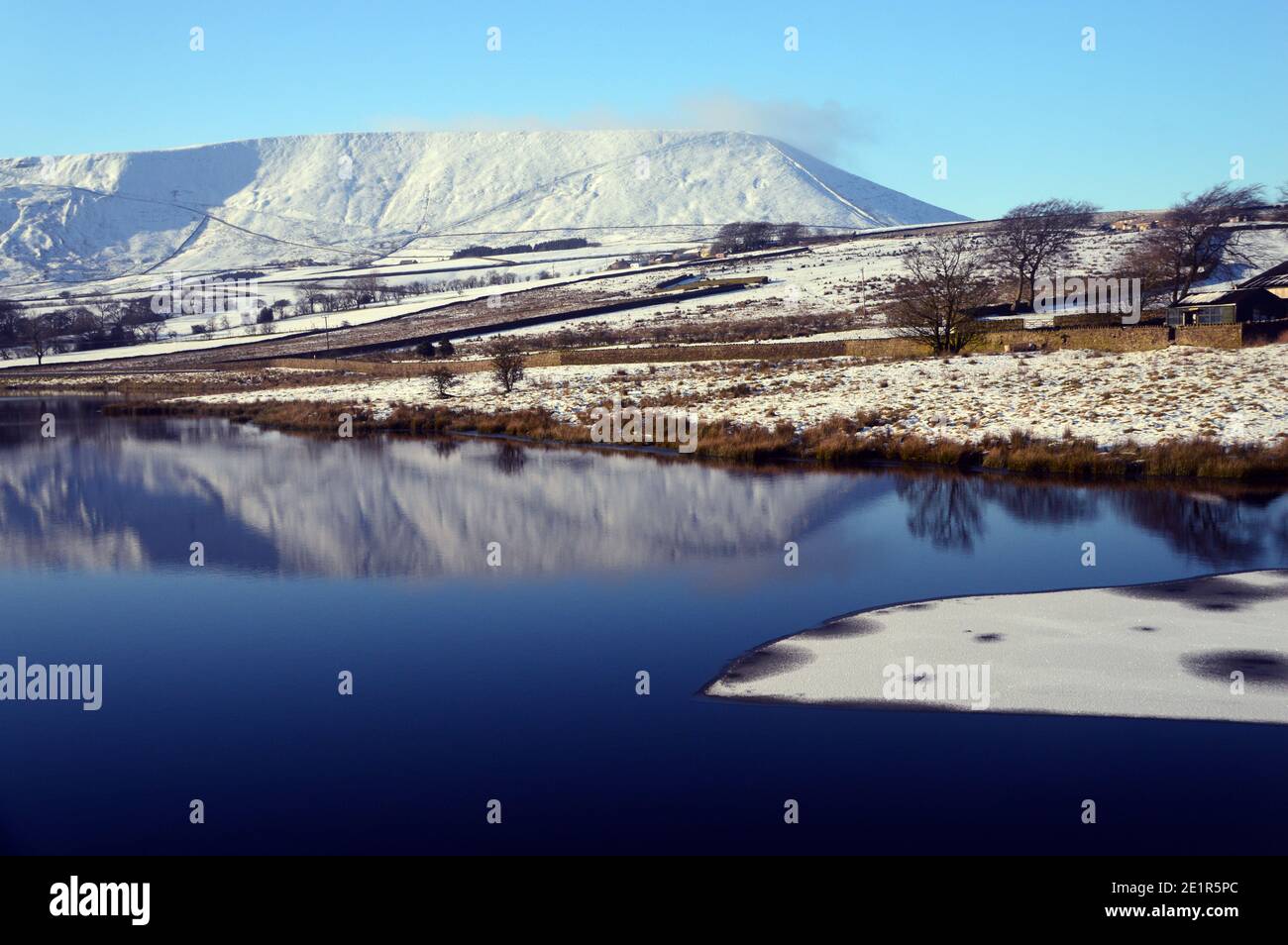 Reflections of Pendle Hill on Lower Black Moss Reservoir in Winter near the Village of Barley, Pendle, Lancashire. UK. Stock Photo